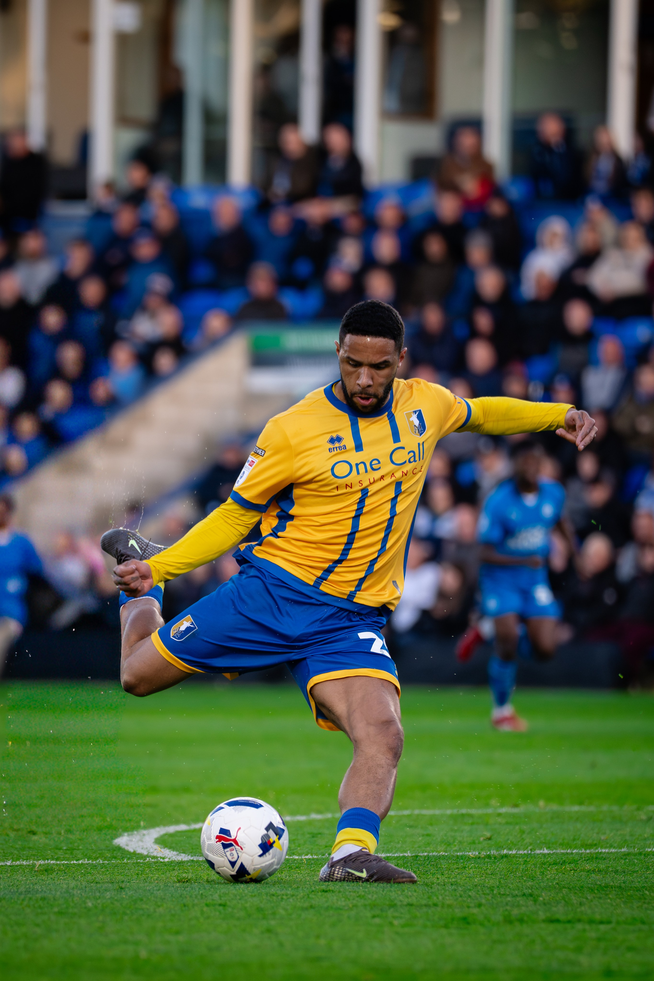 Mansfield Town player controlling the ball during the League One fixture against Peterborough United