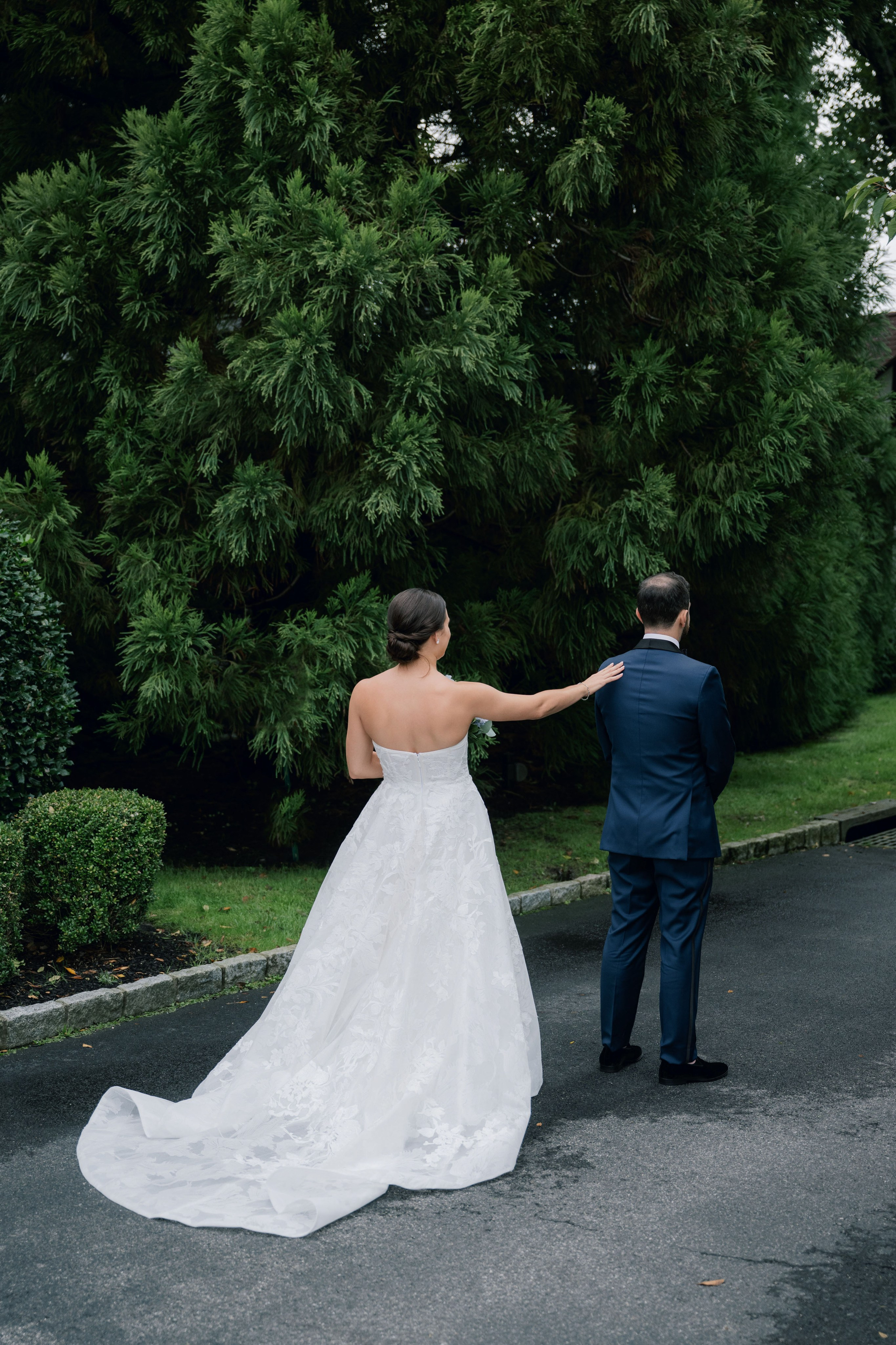 a bride and groom walking down a road