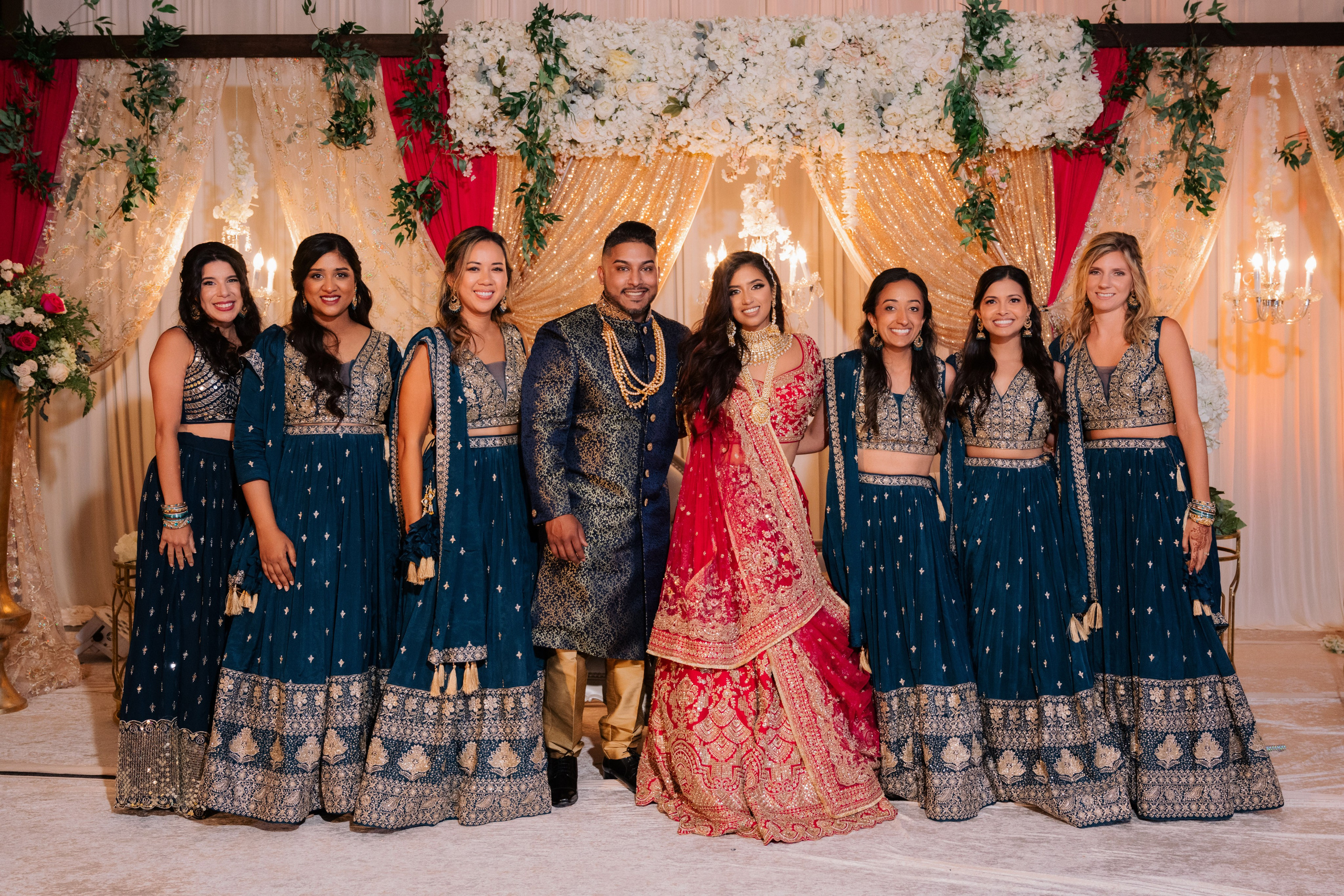 a group of people standing in front of a wedding arch