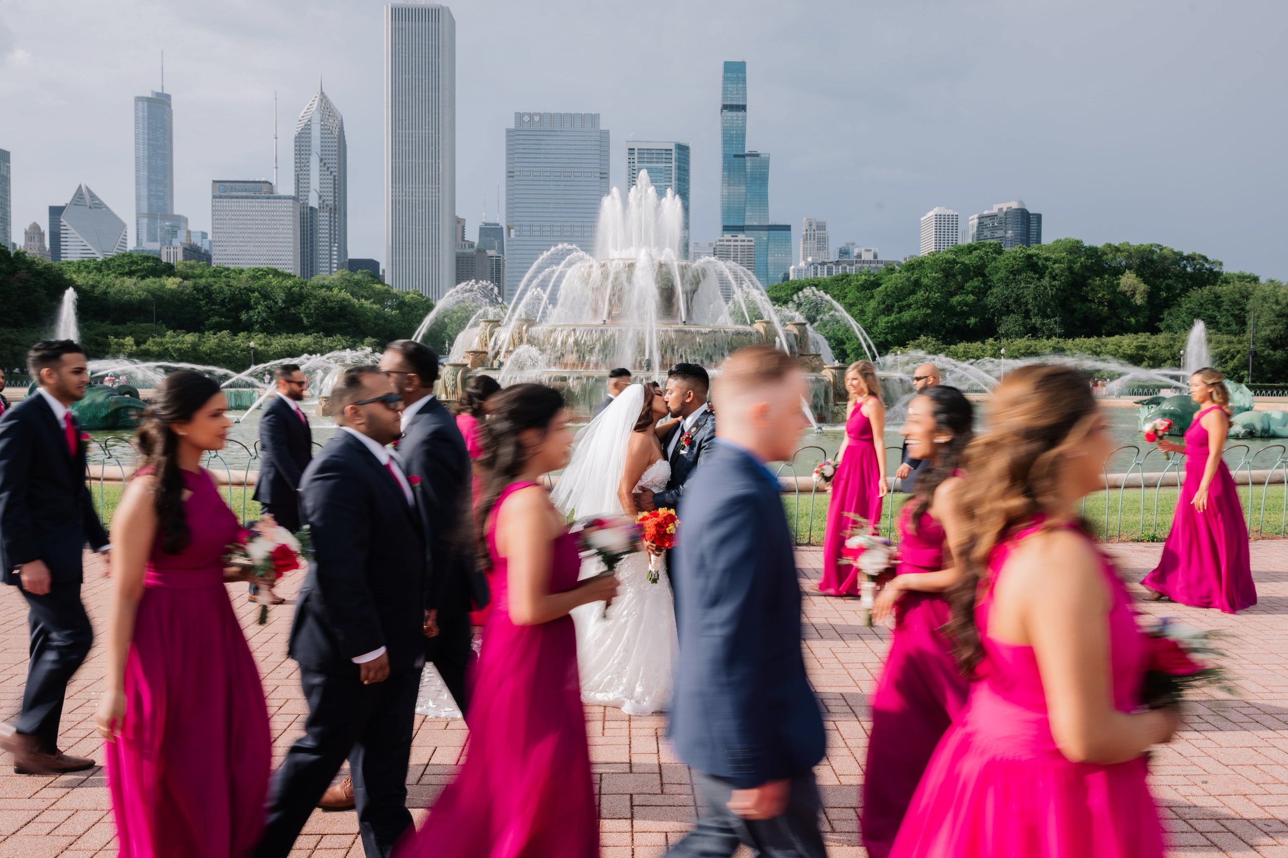 a group of people walking around a fountain