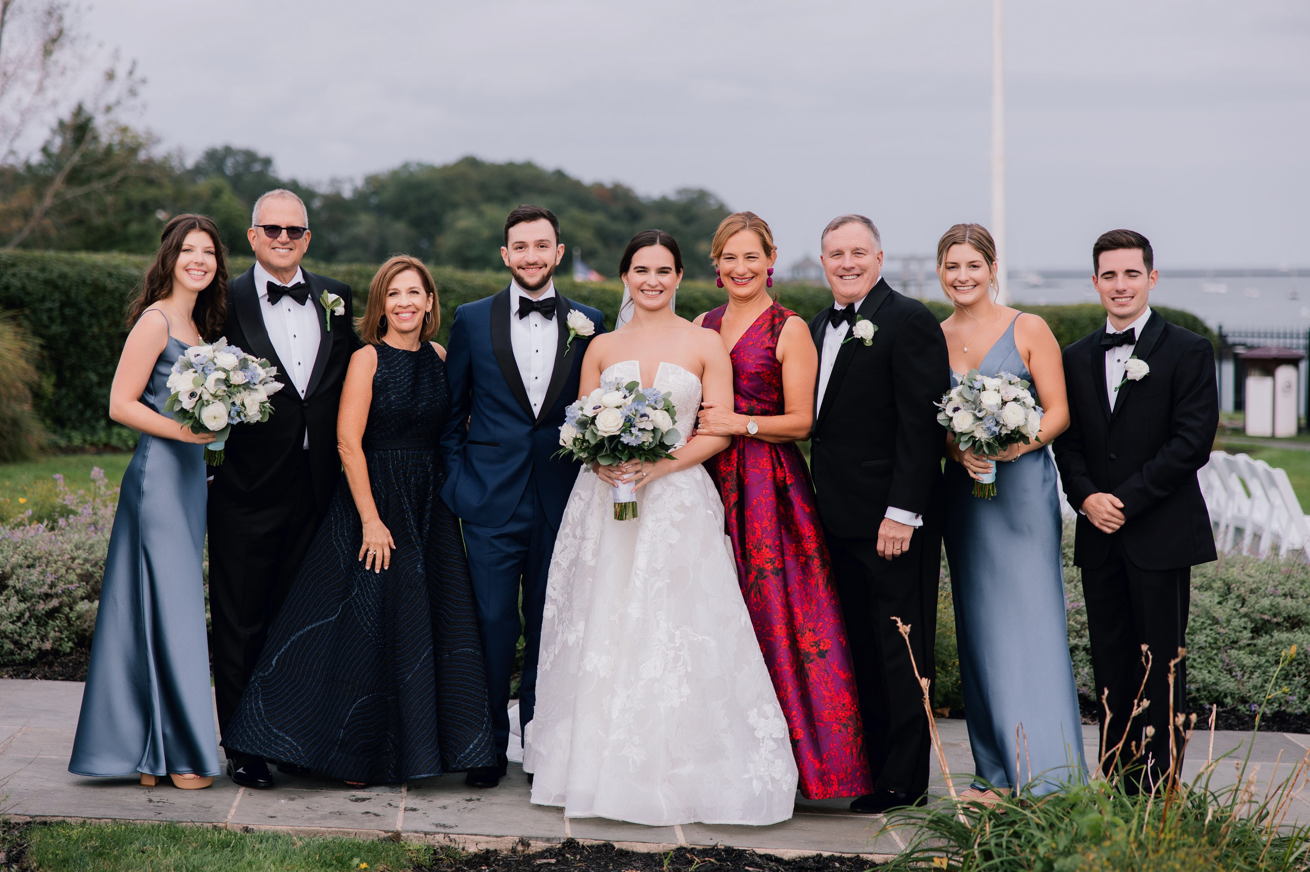 a group of people standing together in formal attire