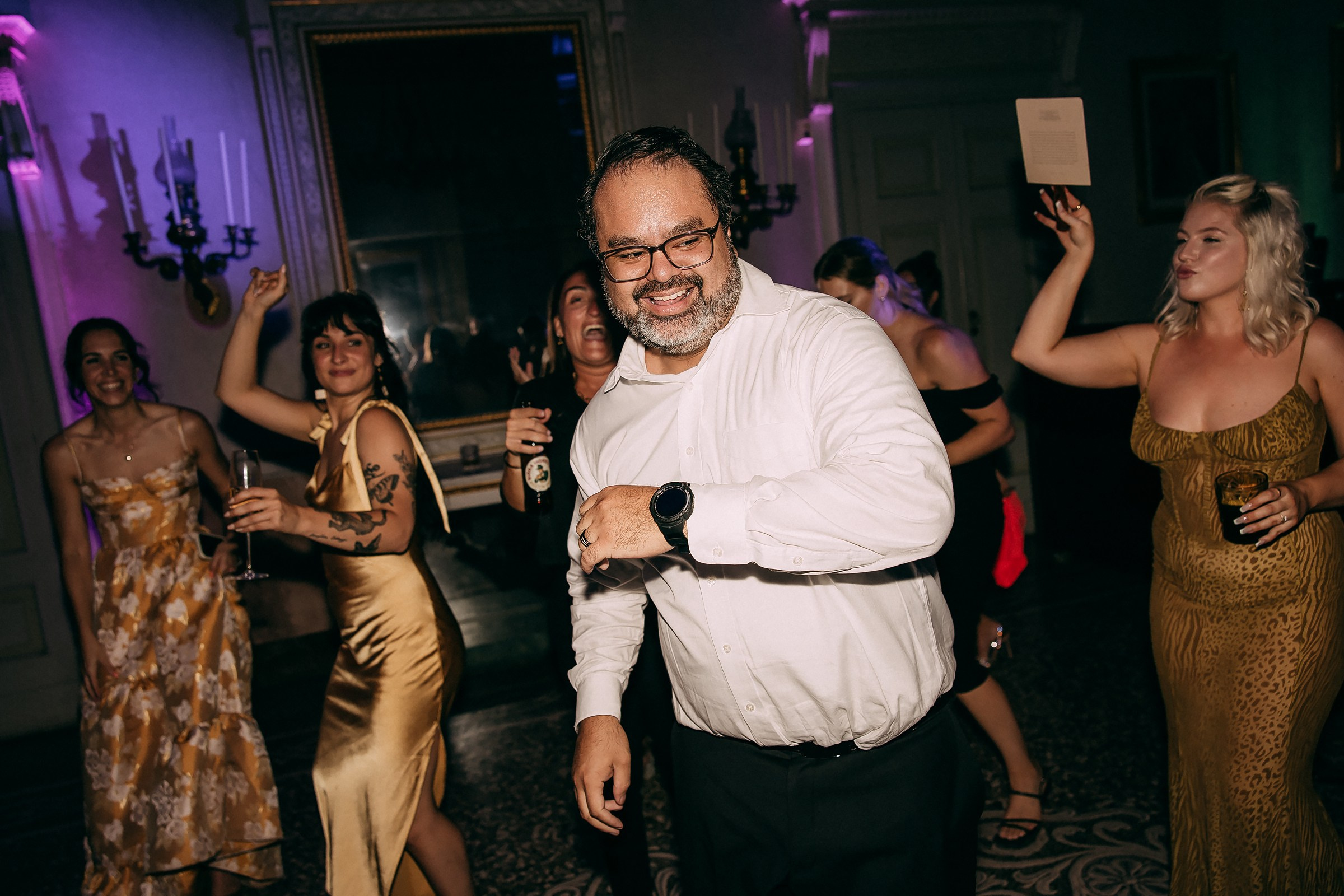Guests dancing and smiling, fully immersed in the wedding festivities.