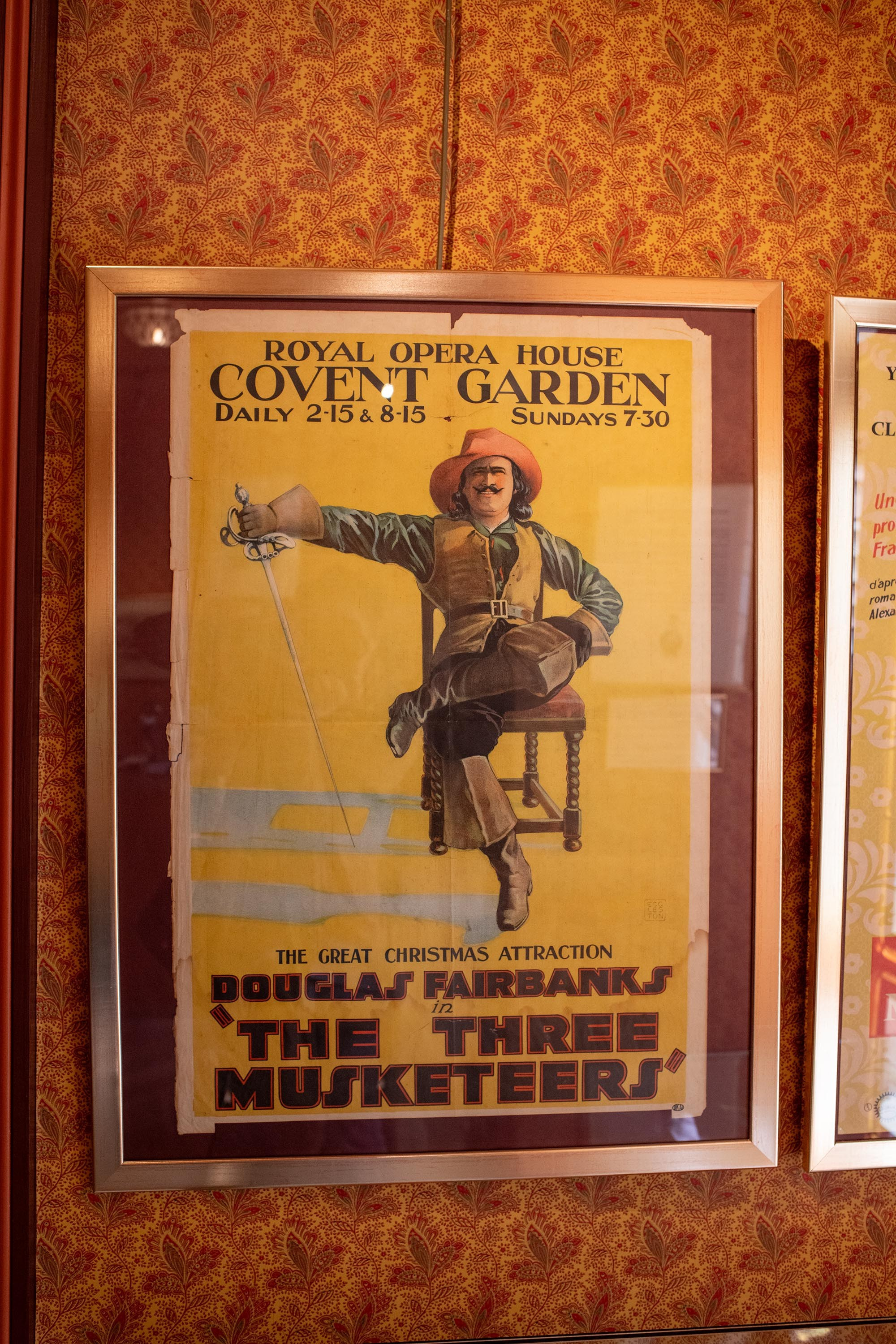 Vintage The Three Musketeers poster featuring Douglas Fairbanks displayed at the Château de Monte-Cristo museum