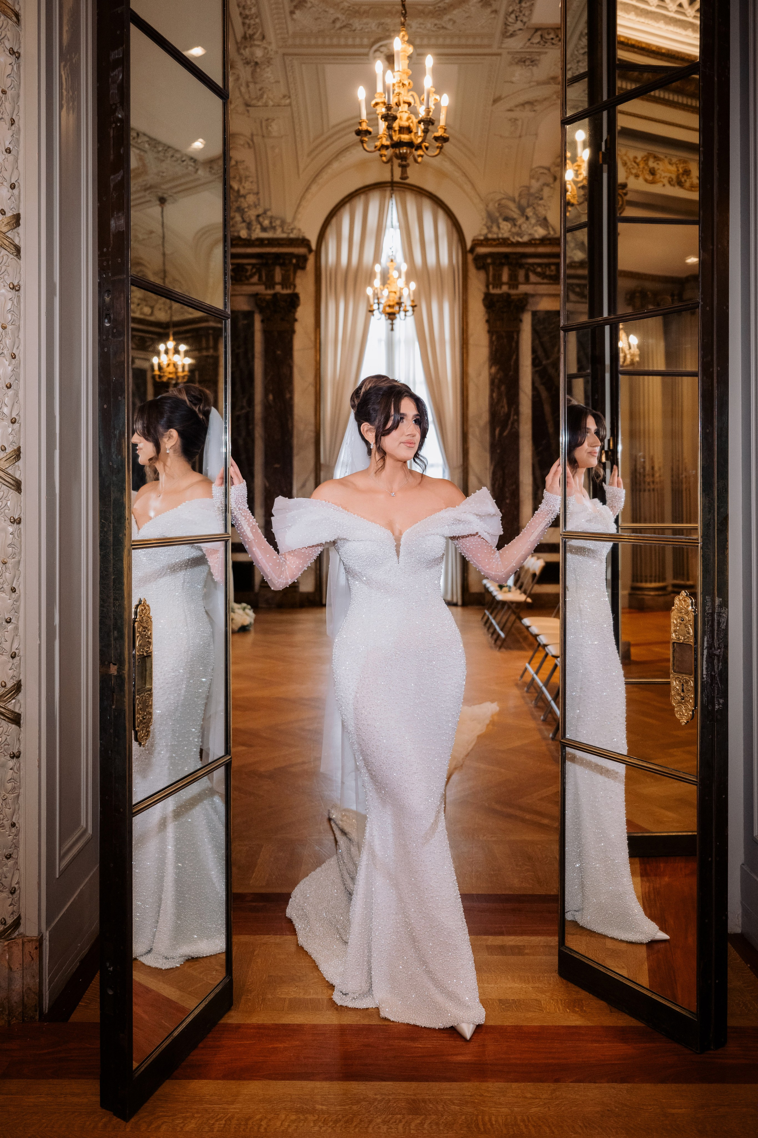a woman in a wedding dress is standing in a mirror