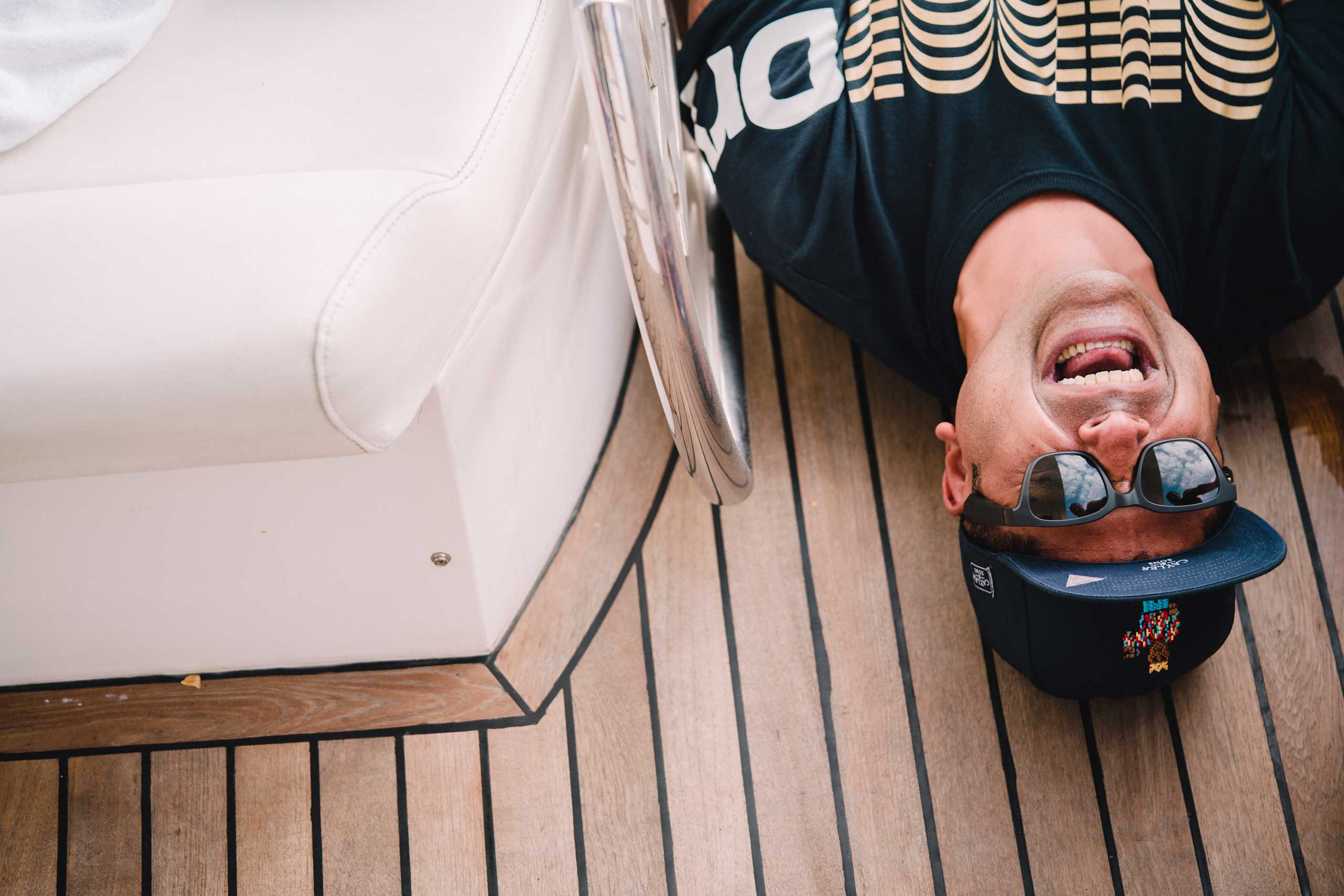 funny indian guy wearing a cap and sunglasses smiling