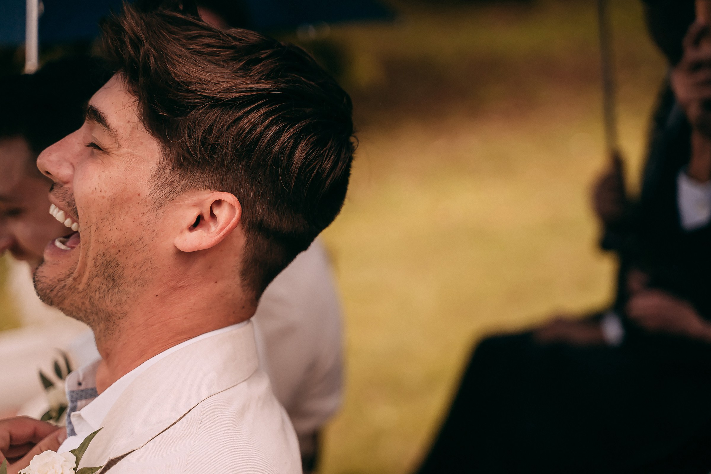 A guest’s infectious laughter lights up the ceremony, embodying the joy and warmth of the moment.