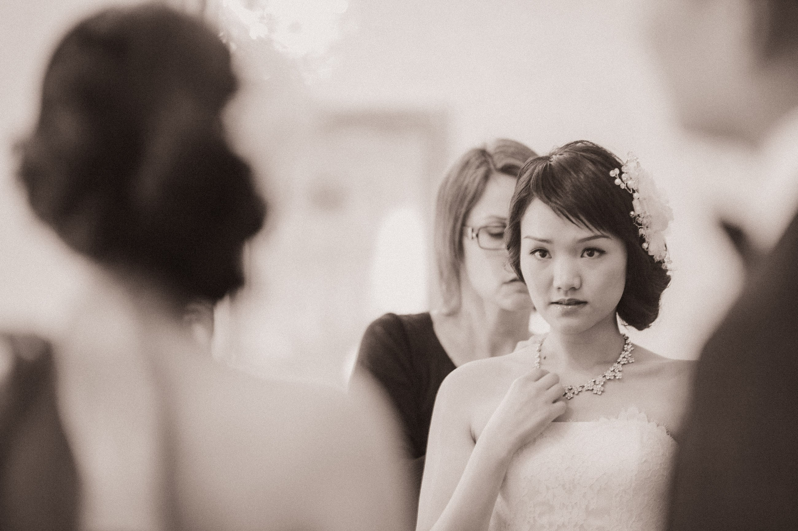 In a luxurious suite in Prague, a Hong Kong bride is seen in the final stages of her bridal preparation.