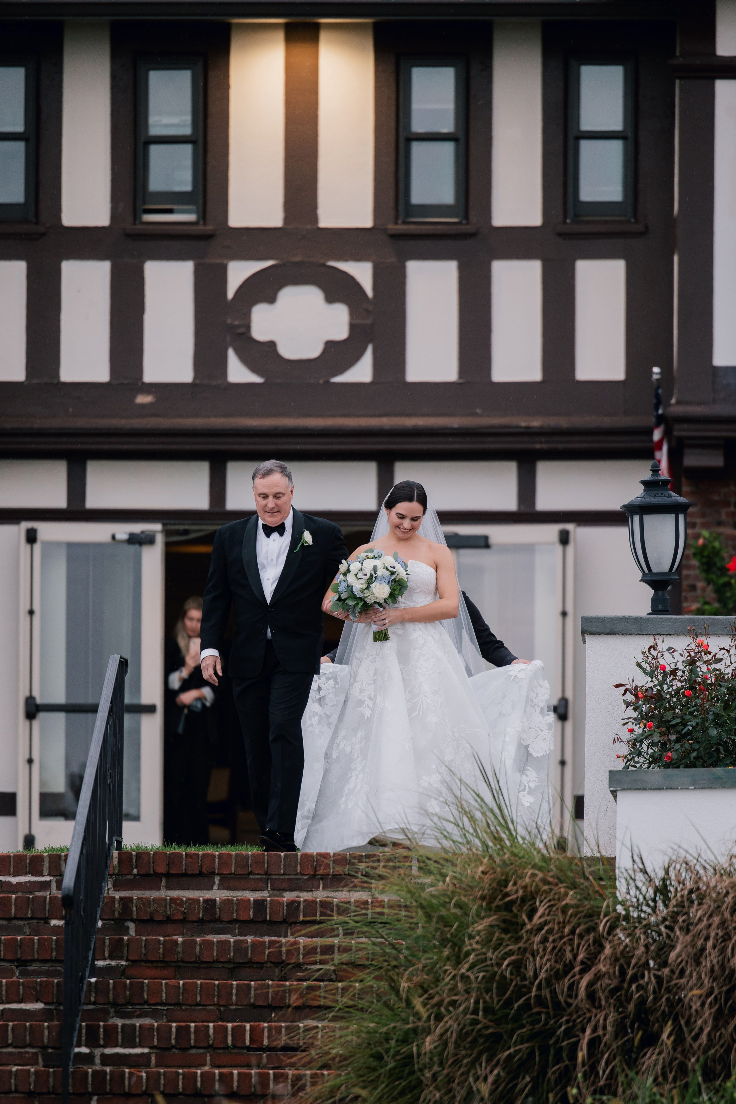 a bride and groom walking down the stairs