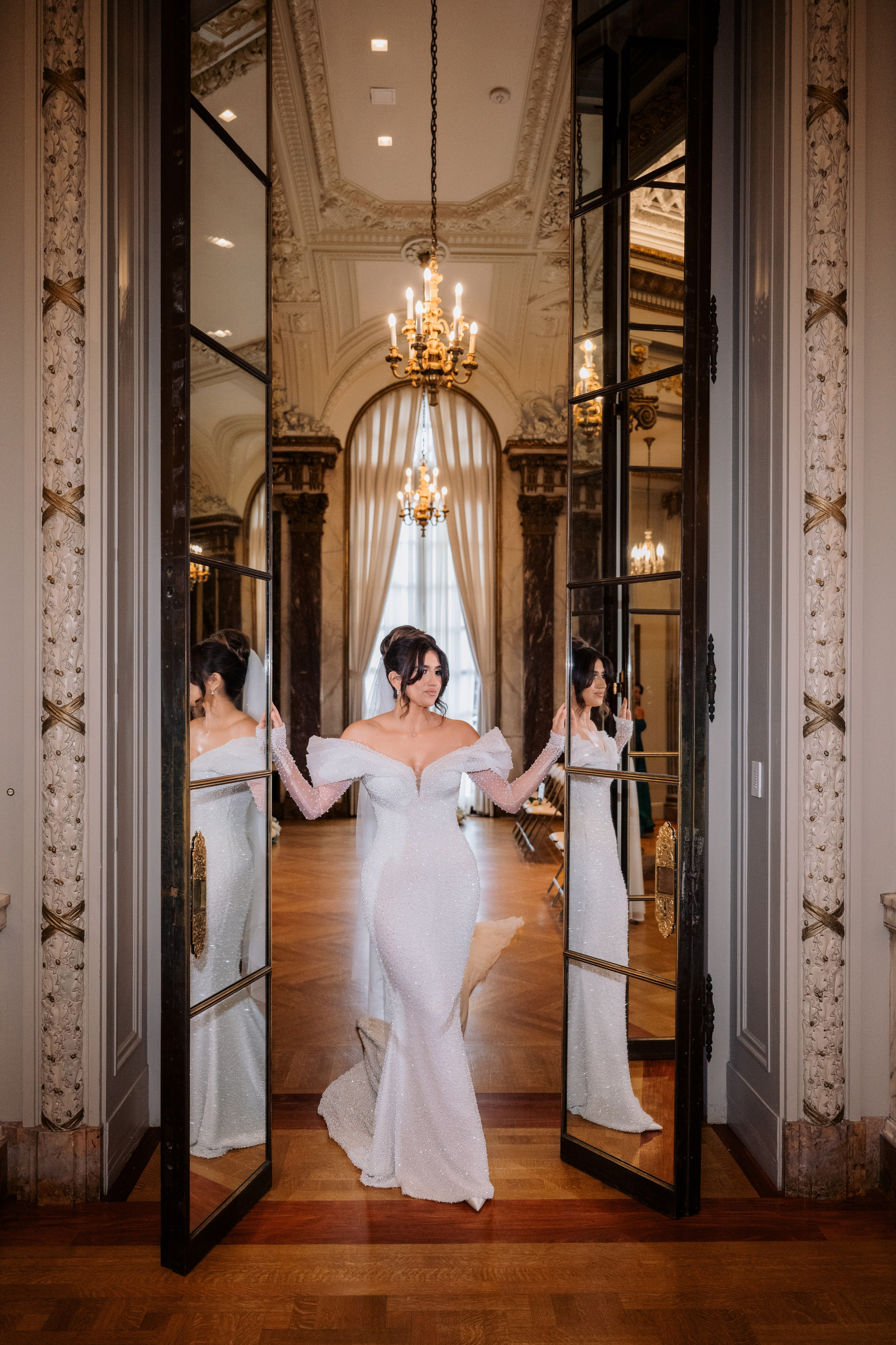 a bride is standing in front of a mirror