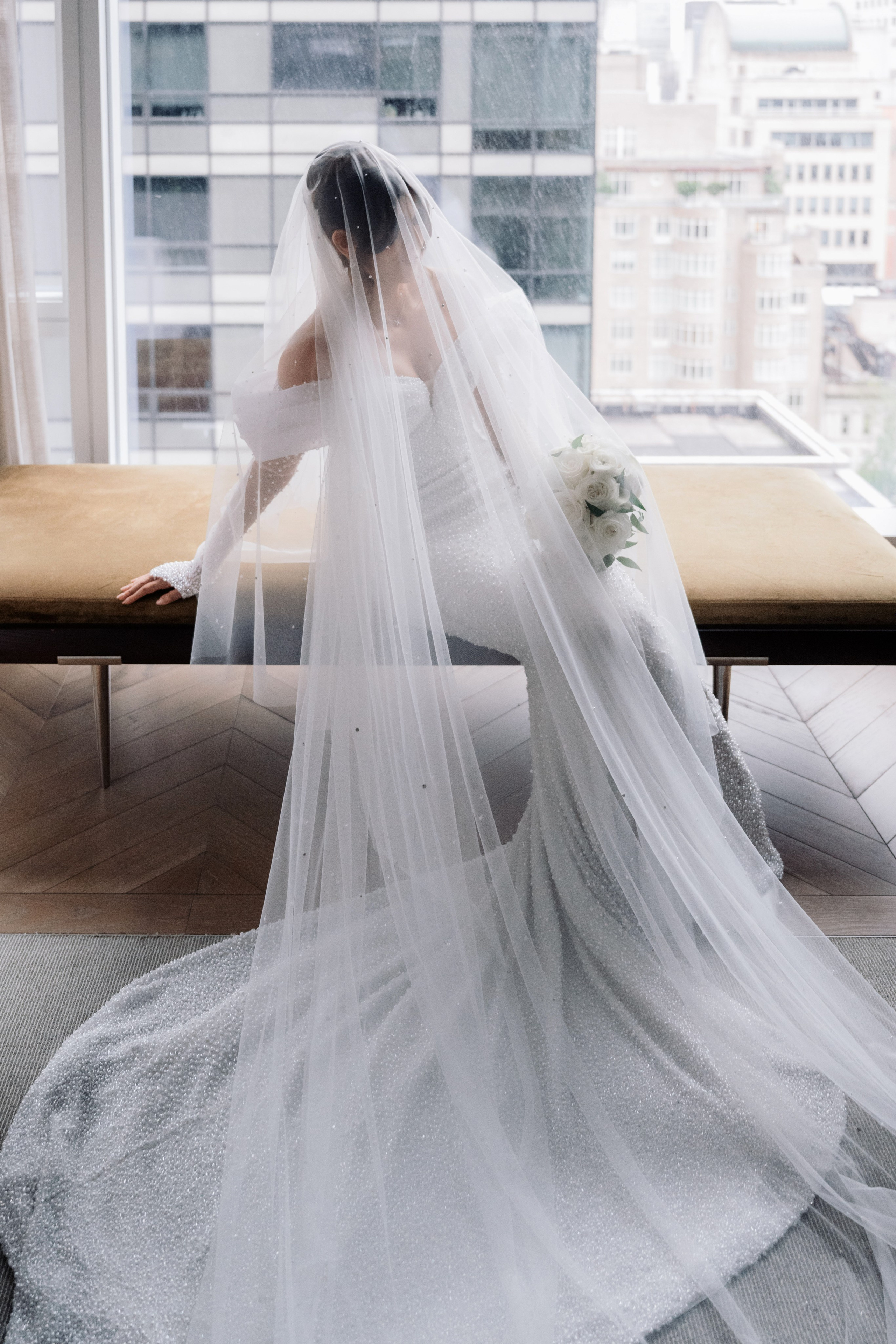 a bride in a white wedding dress and veil