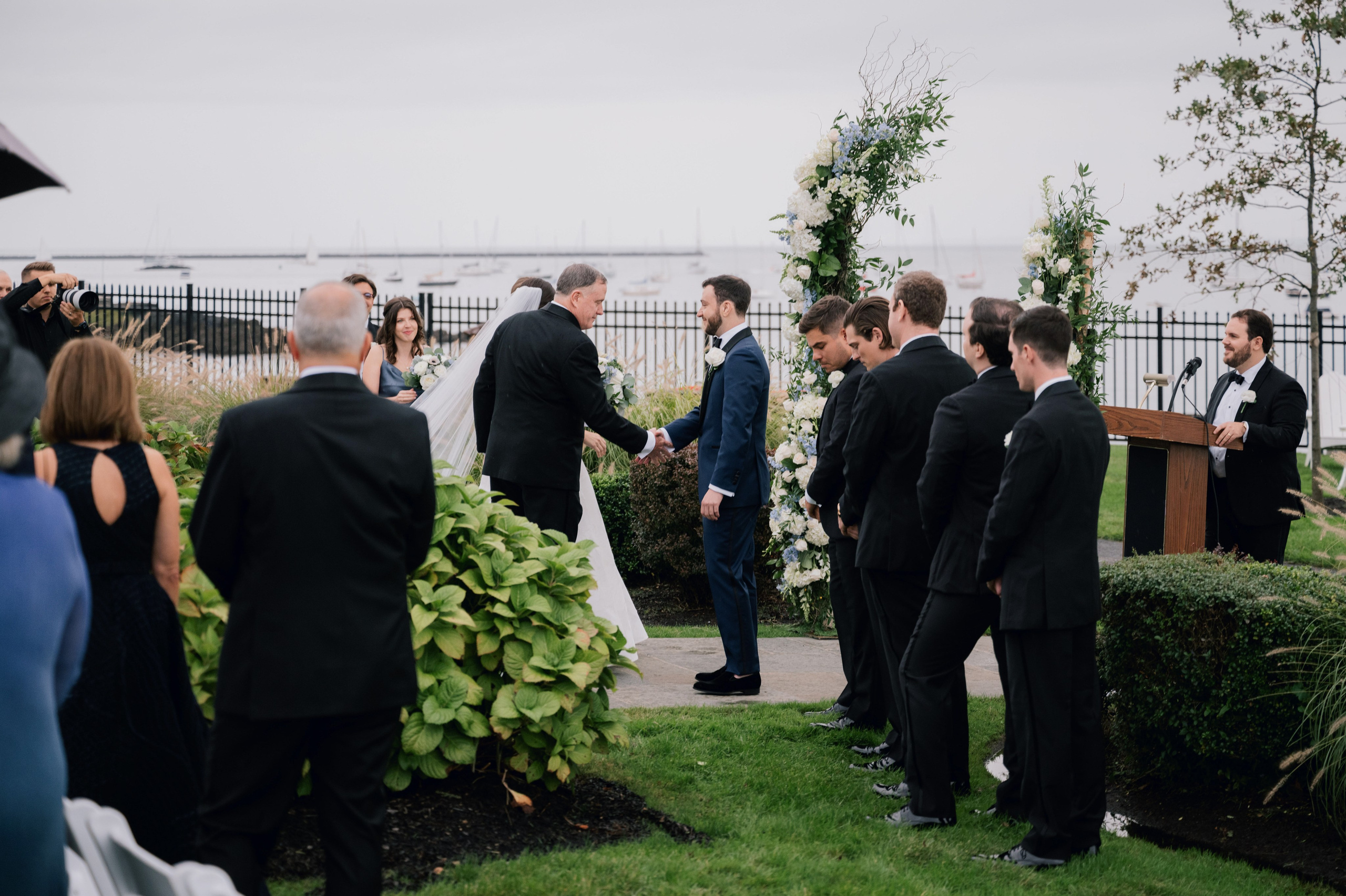 a group of people standing around a wedding ceremony