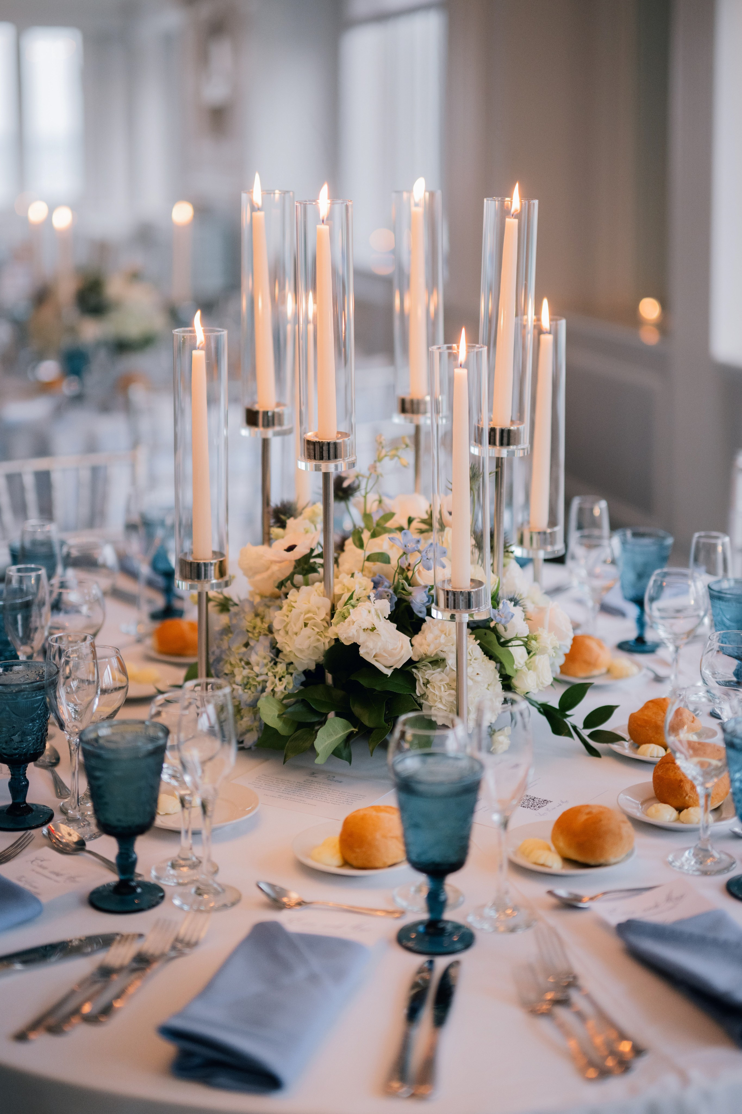 a table with a bunch of flowers and candles