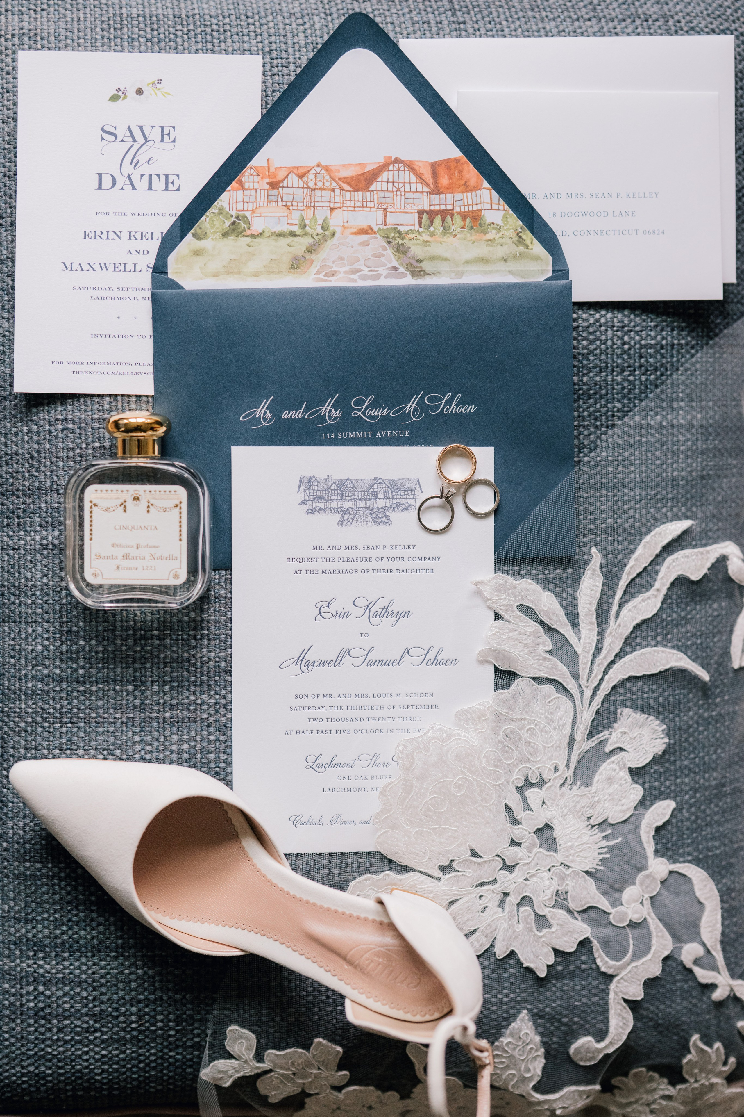 a wedding invitation with a white shoe and a blue envelope