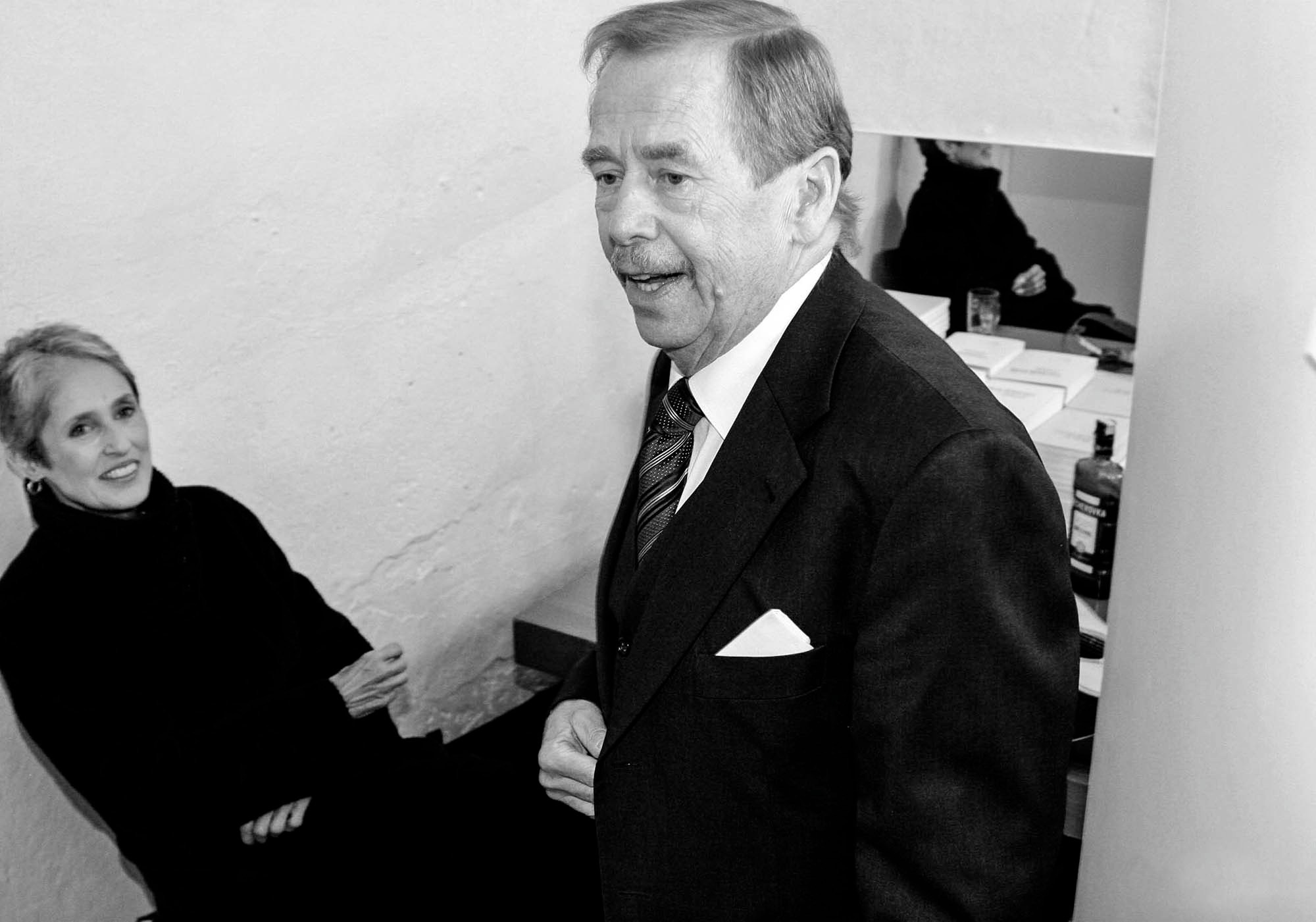 American singer Joan Baez enjoys a shot of Becherovka with then-former Czech President Vaclav Havel during a private moment backstage.