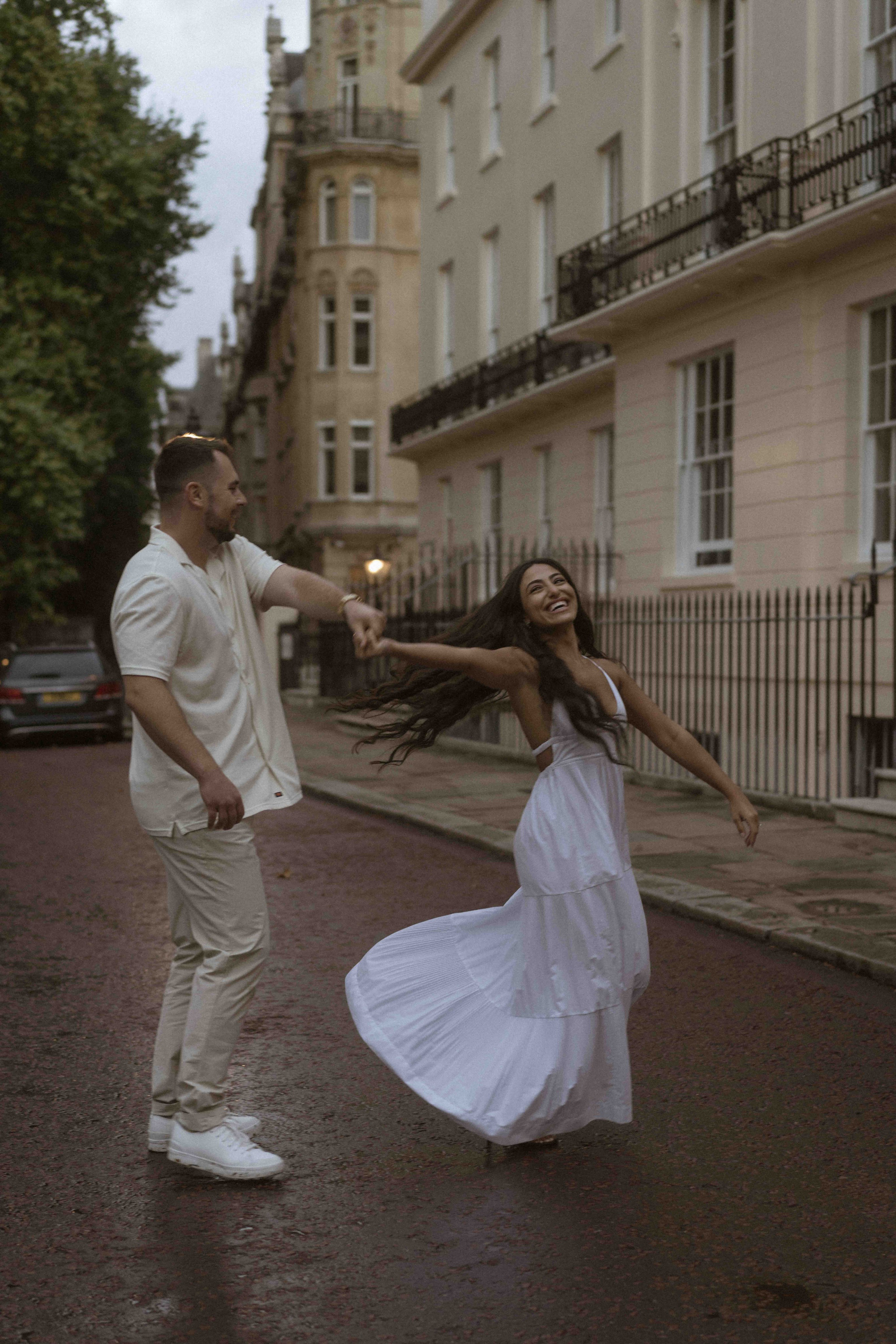 Romantic couple embracing at sunset in London after engagement proposal