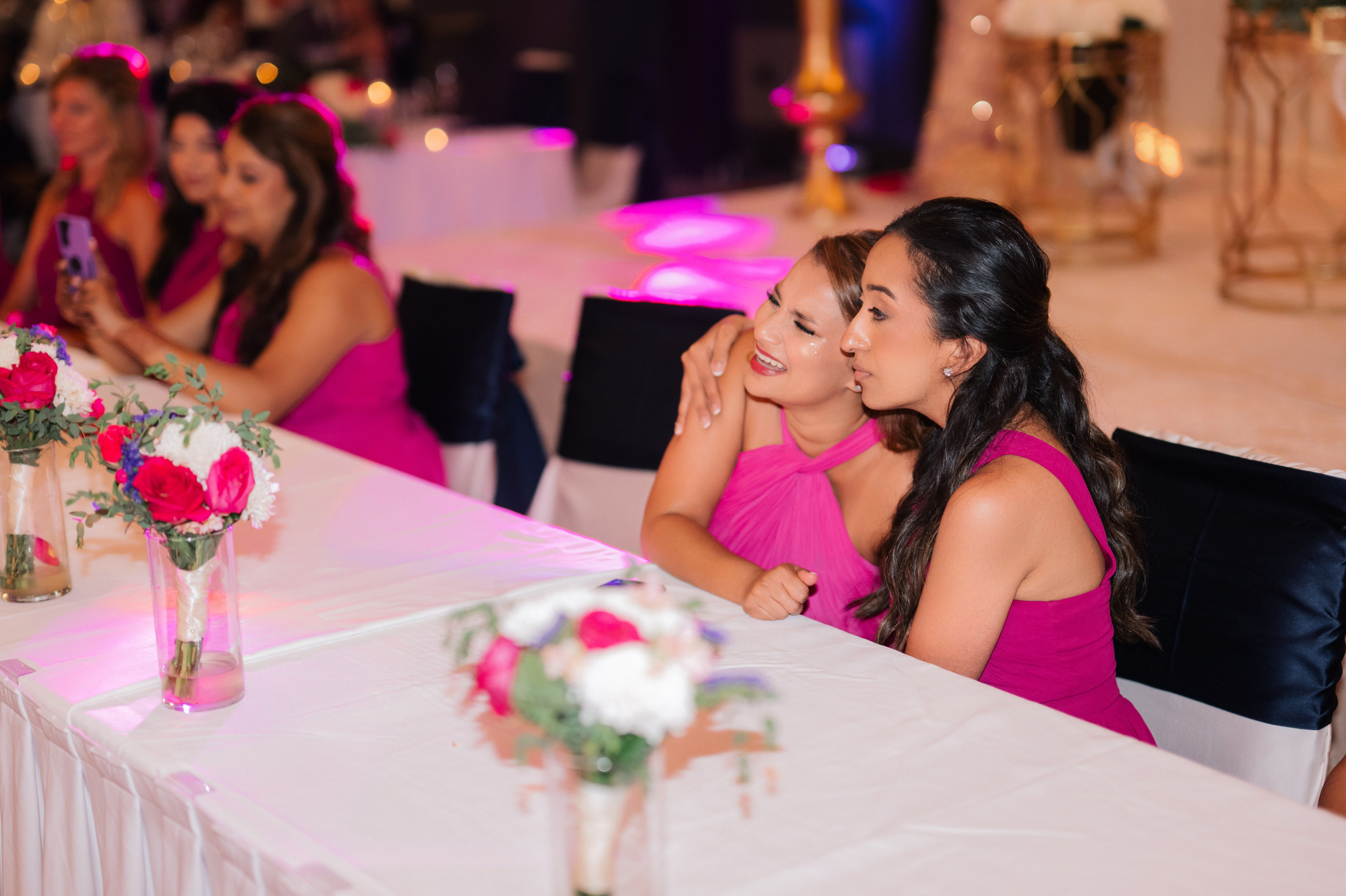 a woman sitting at a table with flowers
