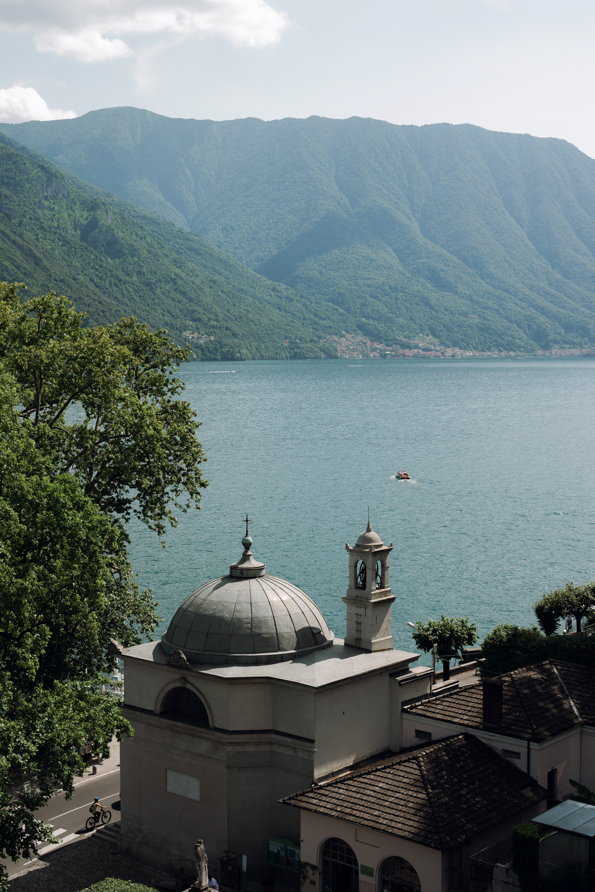 a view of a lake and mountains from a hill