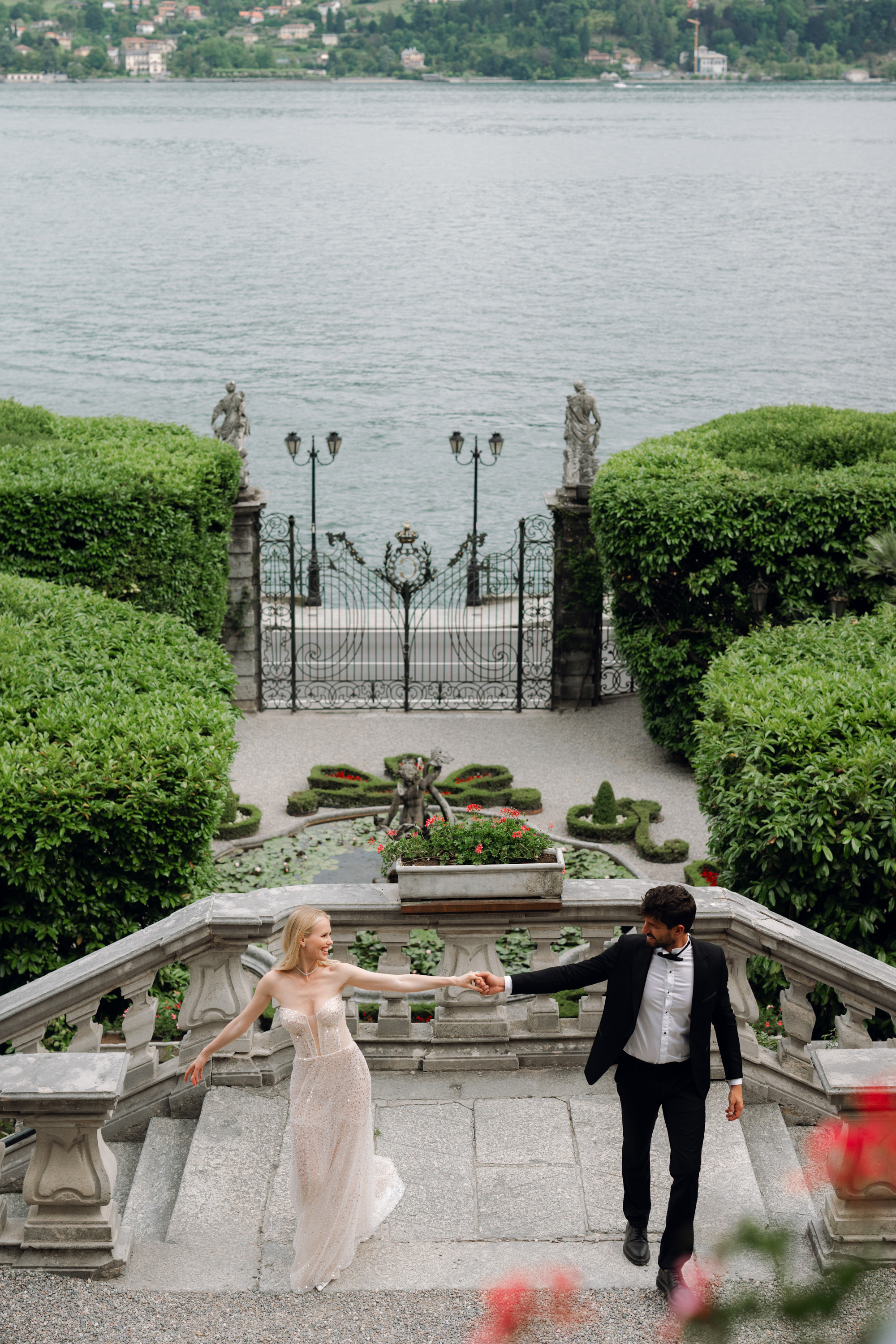 a bride and groom walking down a stone staircase