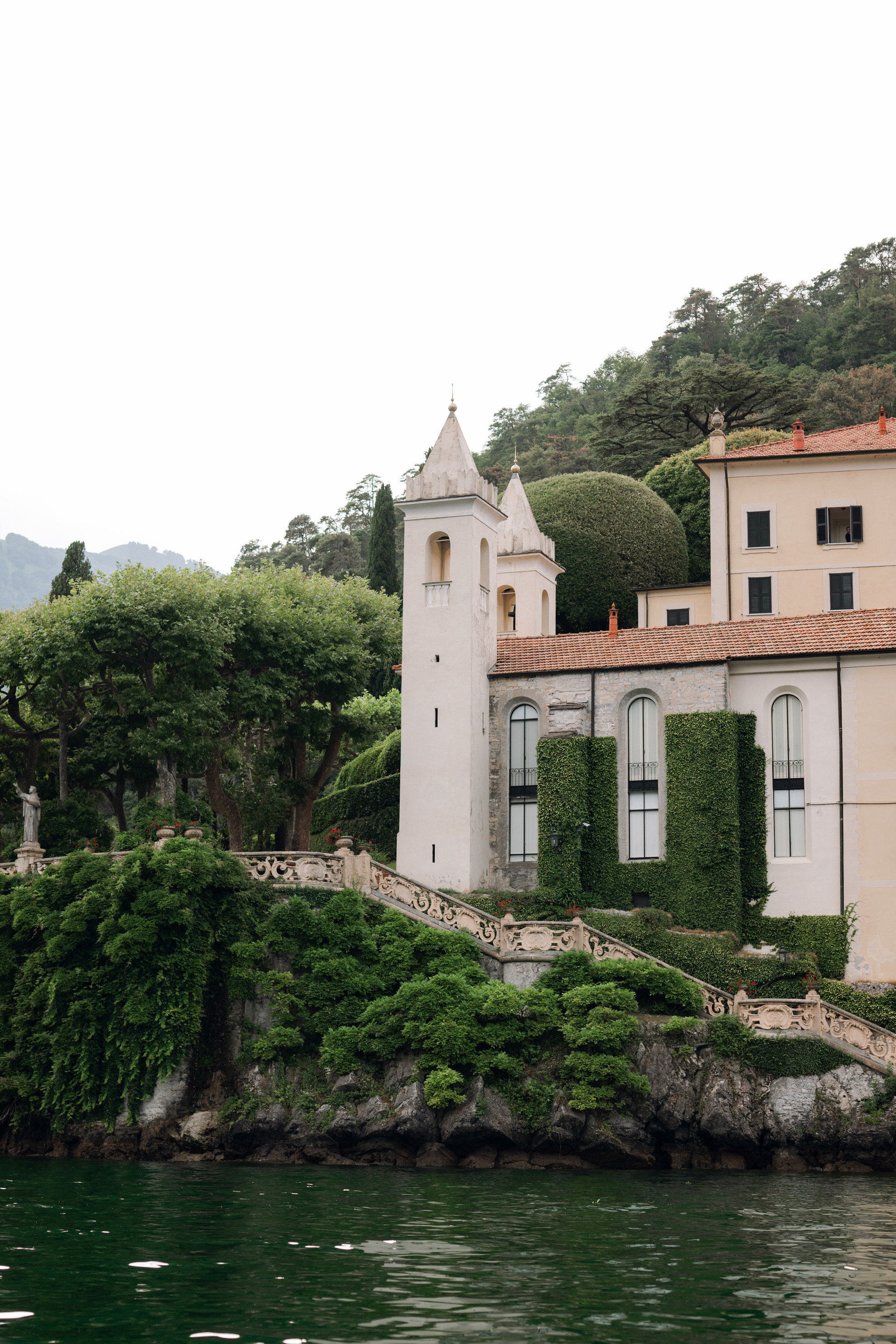 a house on a small island with a boat in the water