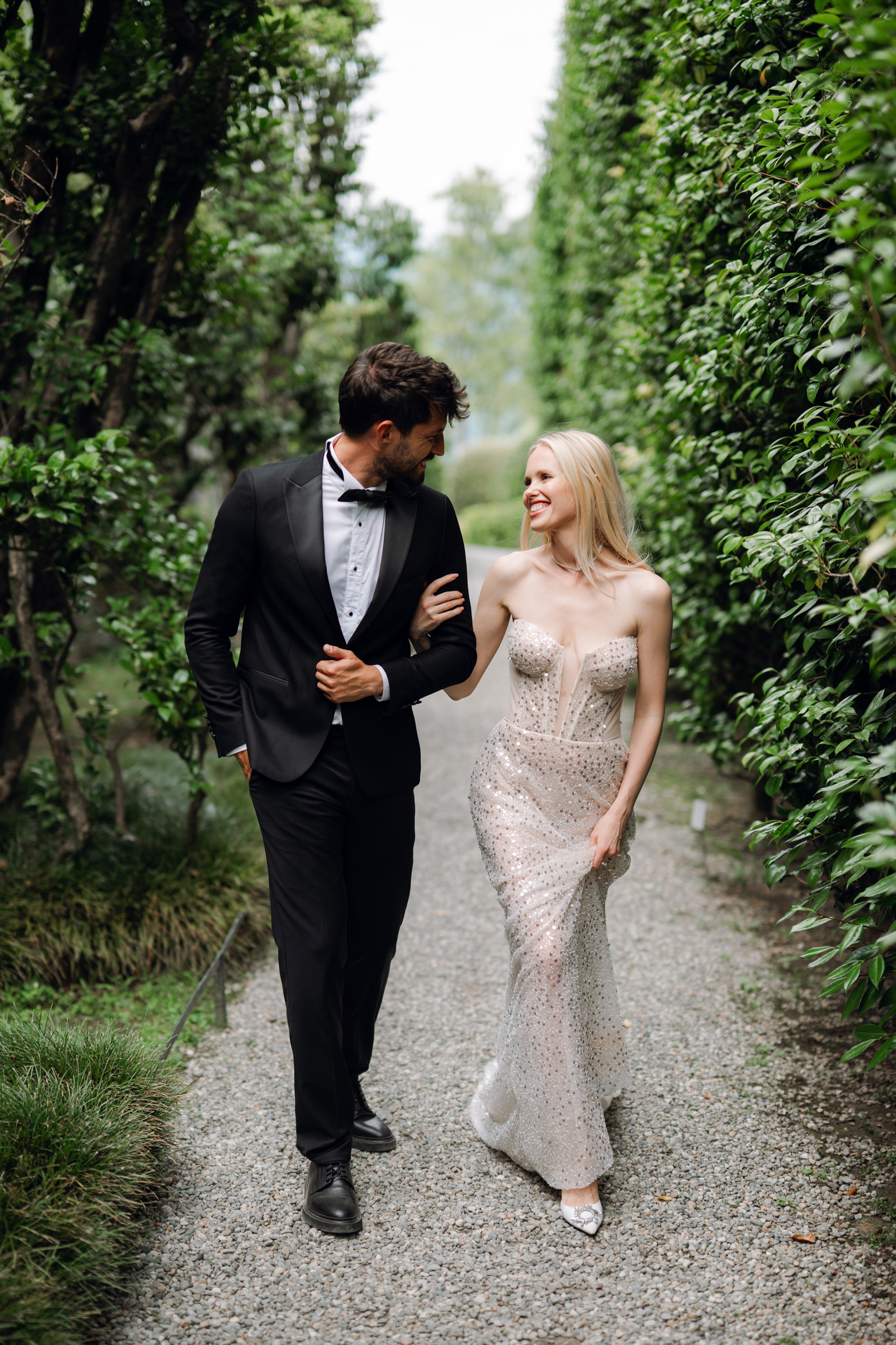 a man and woman walking down a path