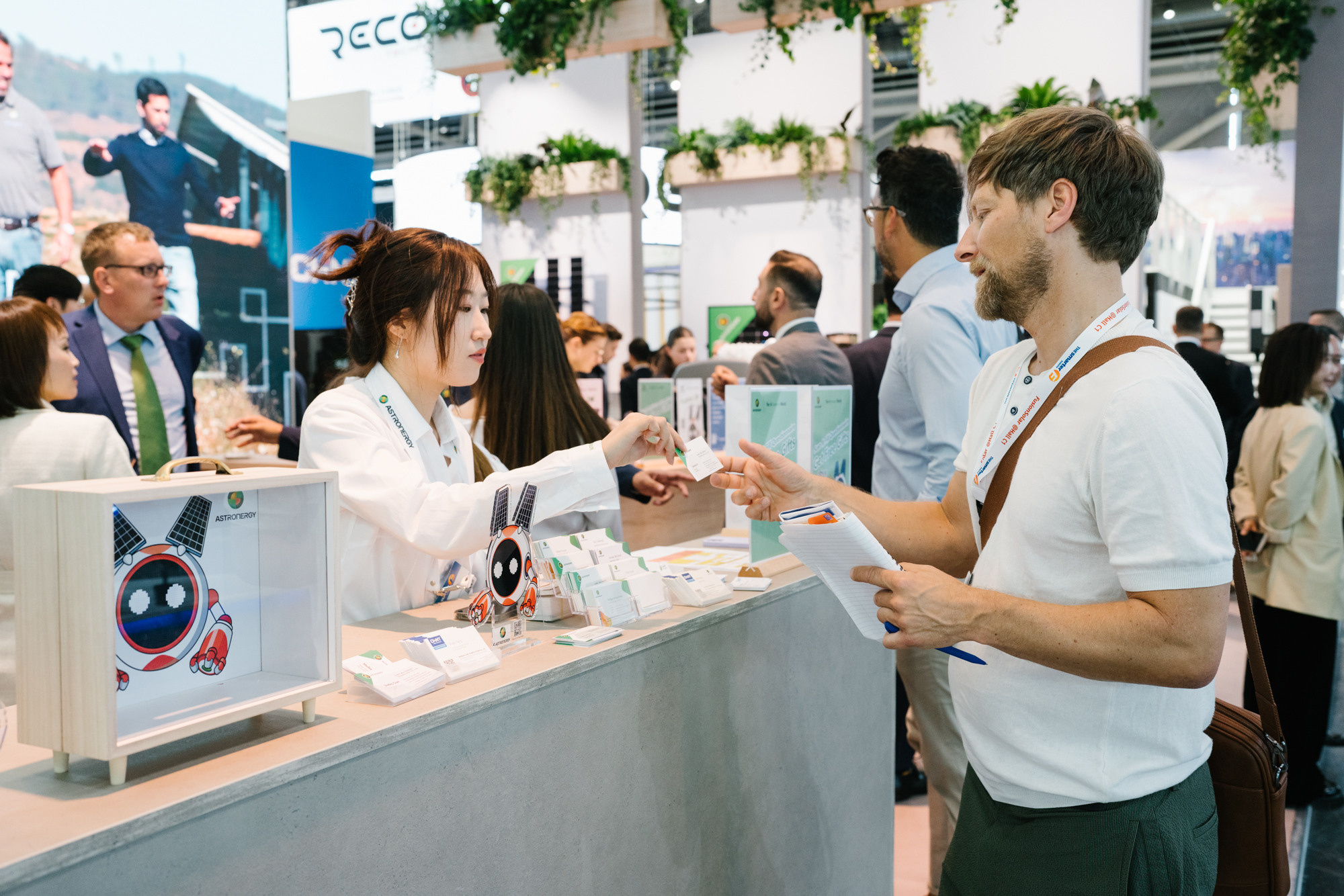 Produktvorführung am Messestand, Besucher sprechen über Solartechnik