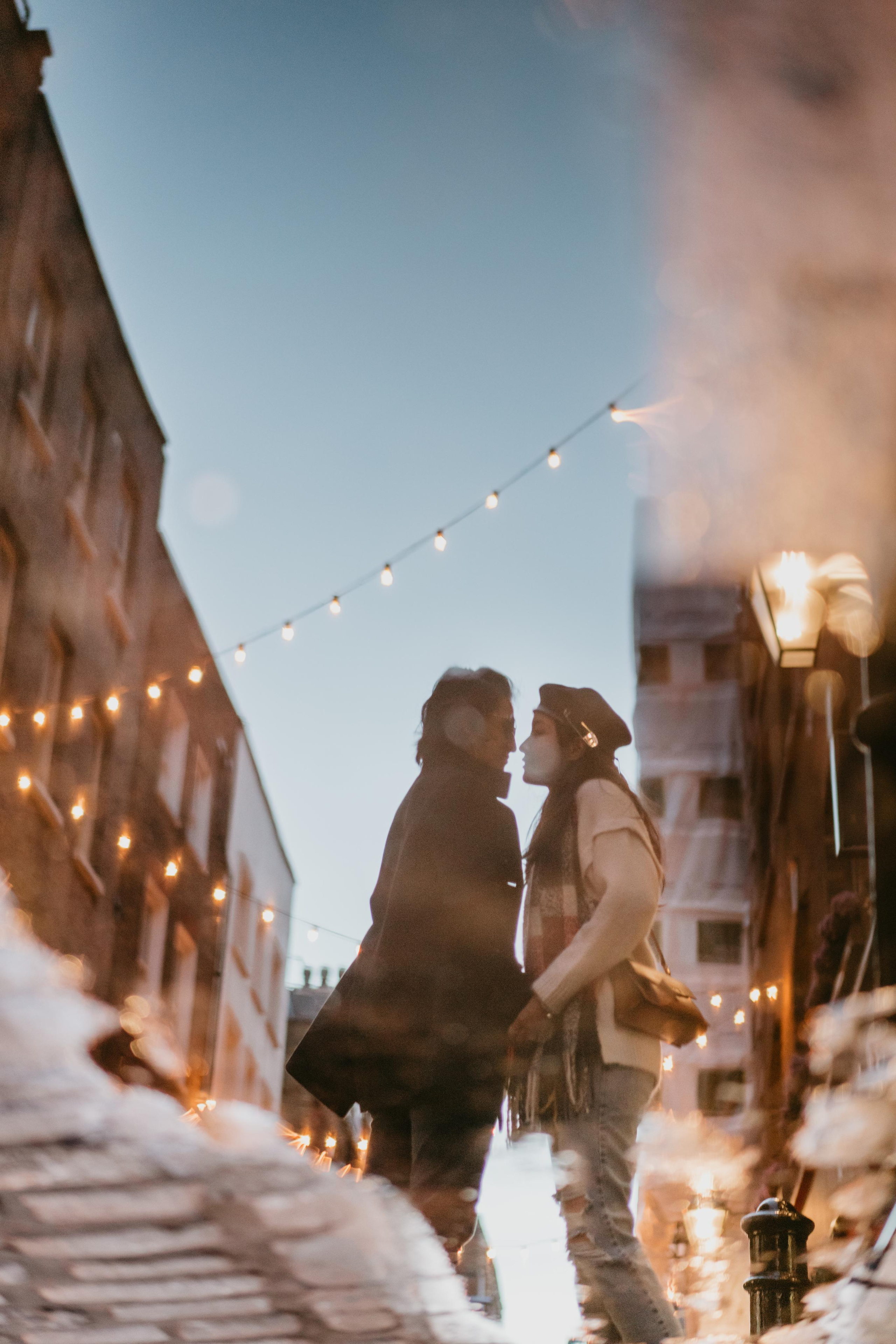 reflection of kissing couple in pond