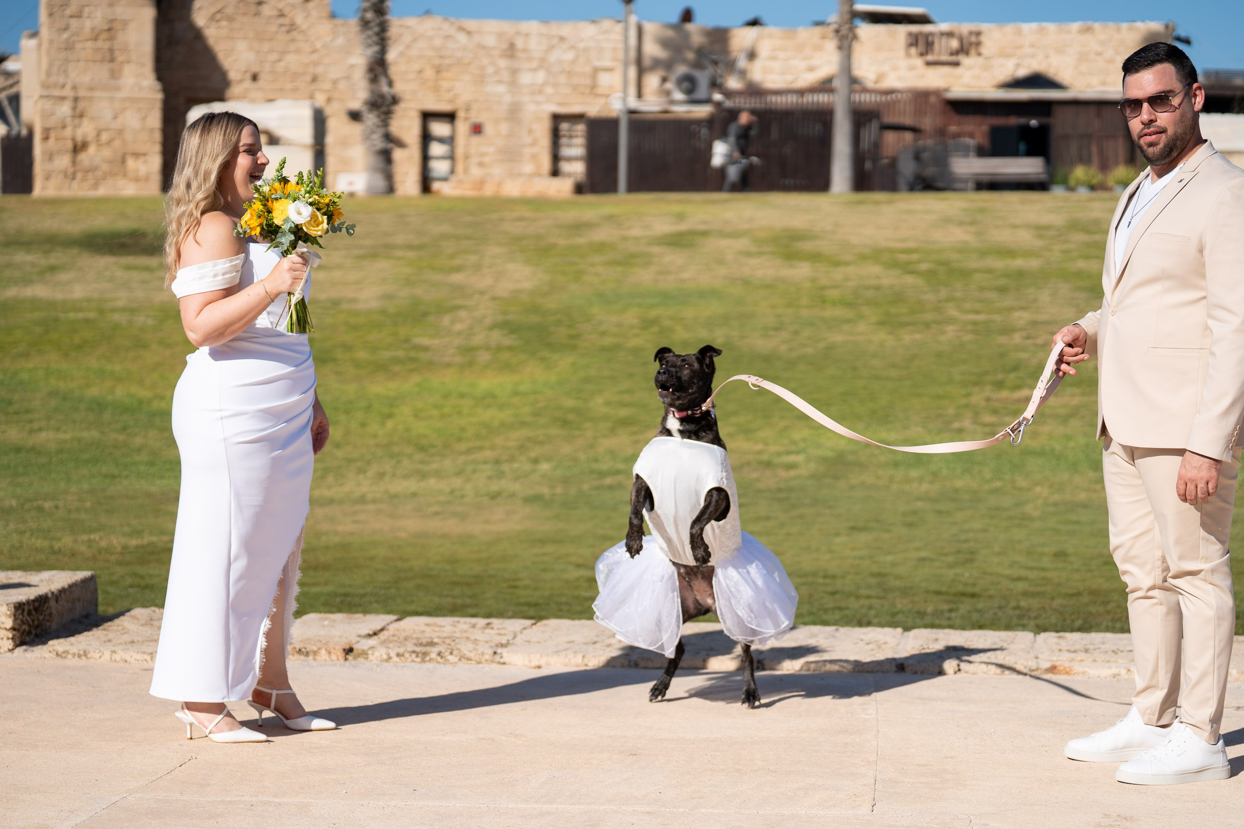 Yael and Natanel share a playful moment with their dog