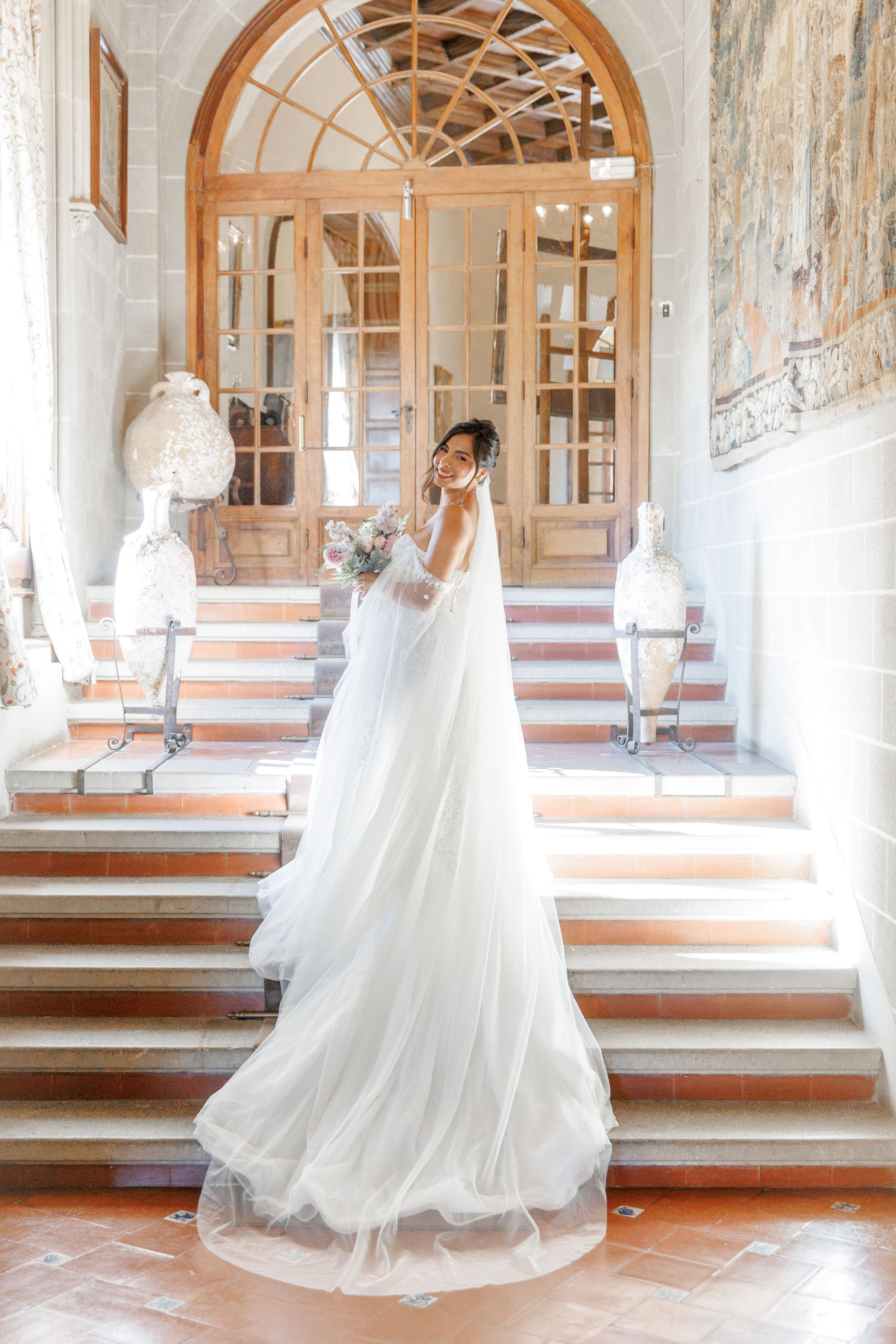 Bridal portrait in a historic wedding venue showcasing the beautiful staircase.