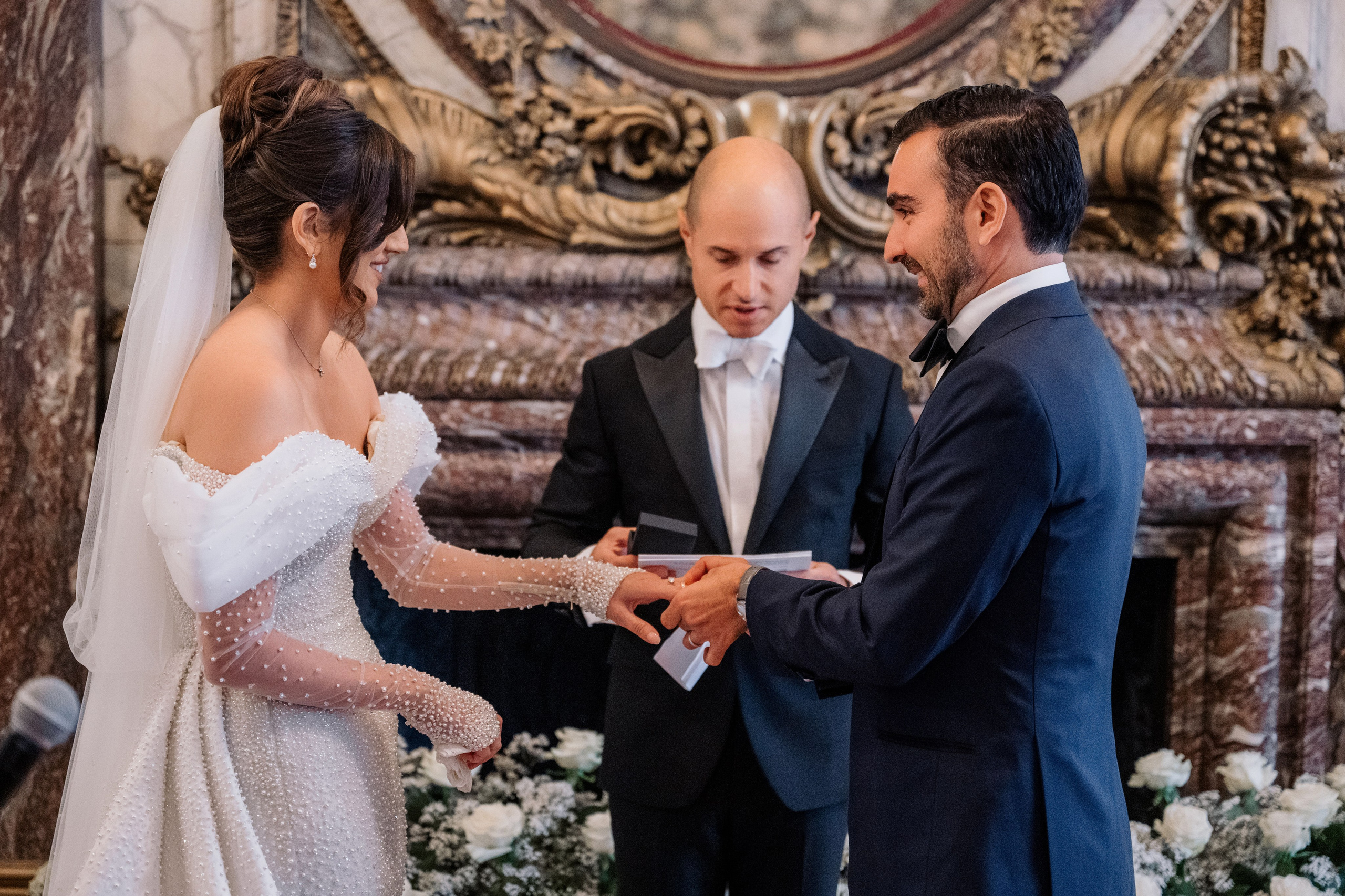 a man and woman are exchanging a wedding ring