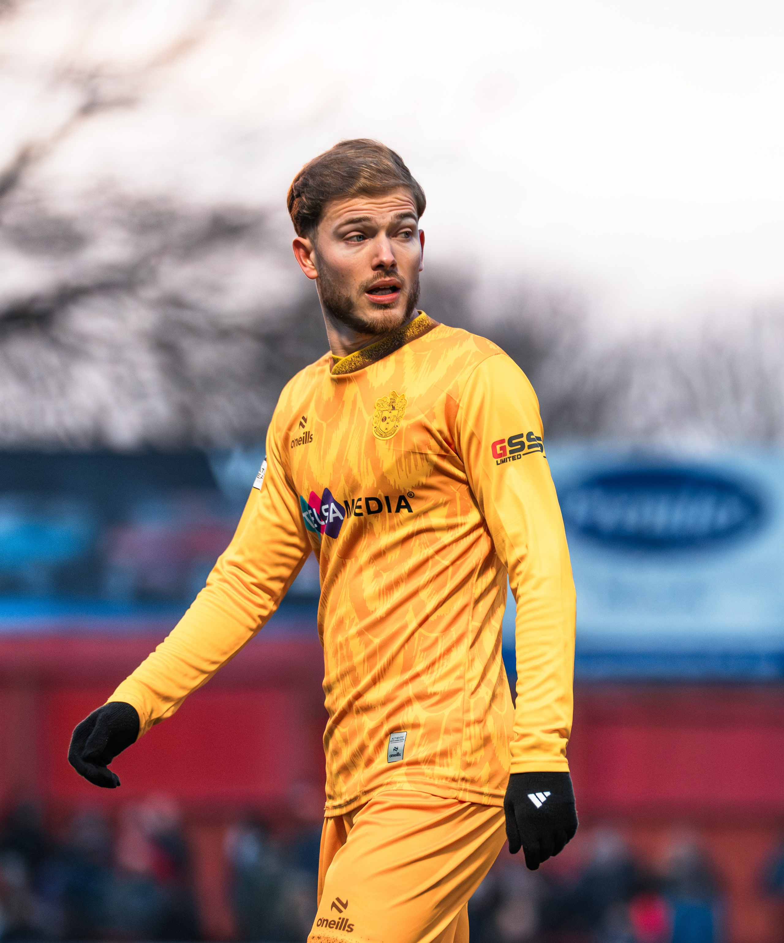 Goalkeeper in yellow kit during a football match, professional matchday football photography in the UK.