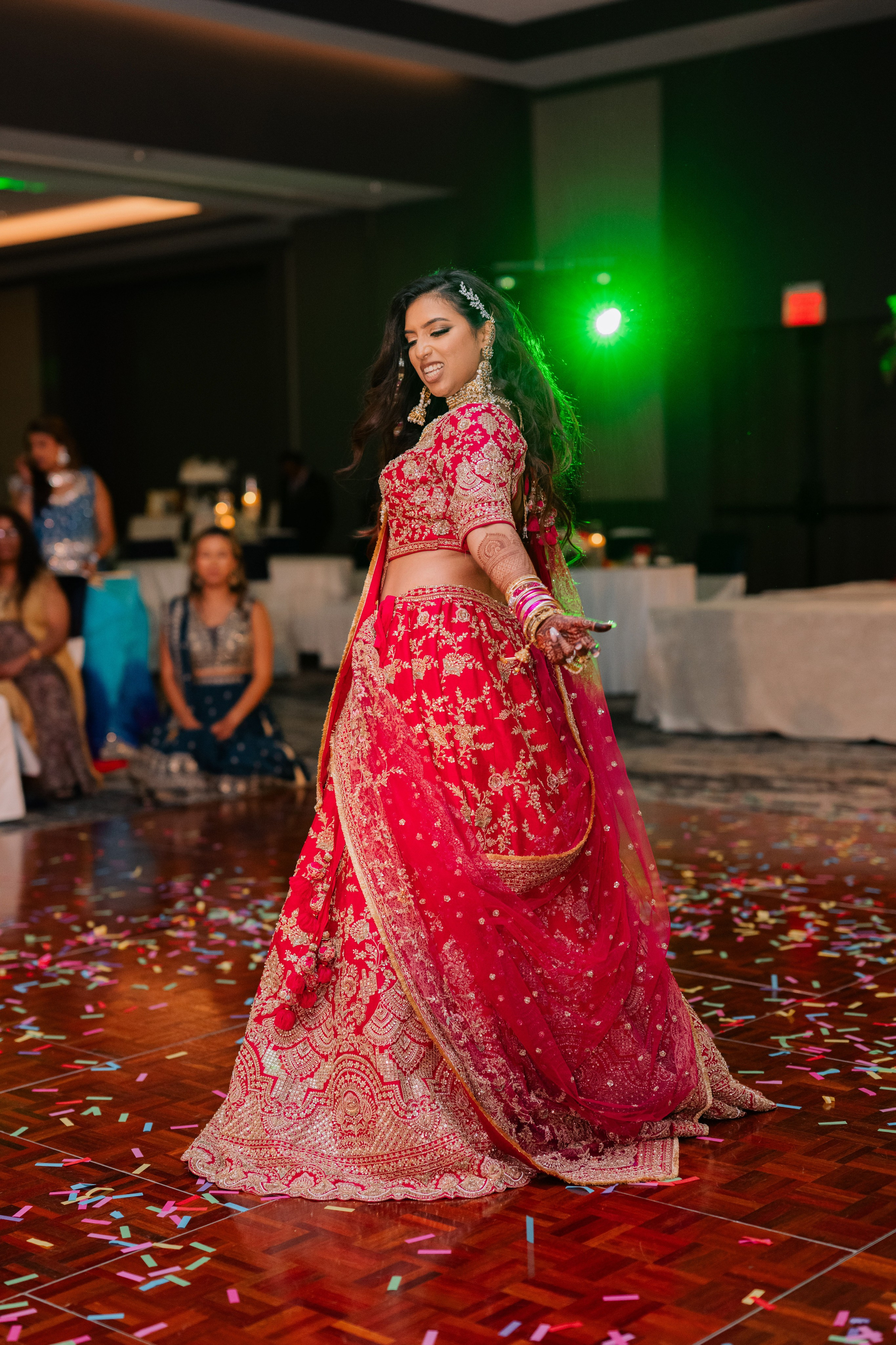 a woman in a red dress dancing on a wooden floor