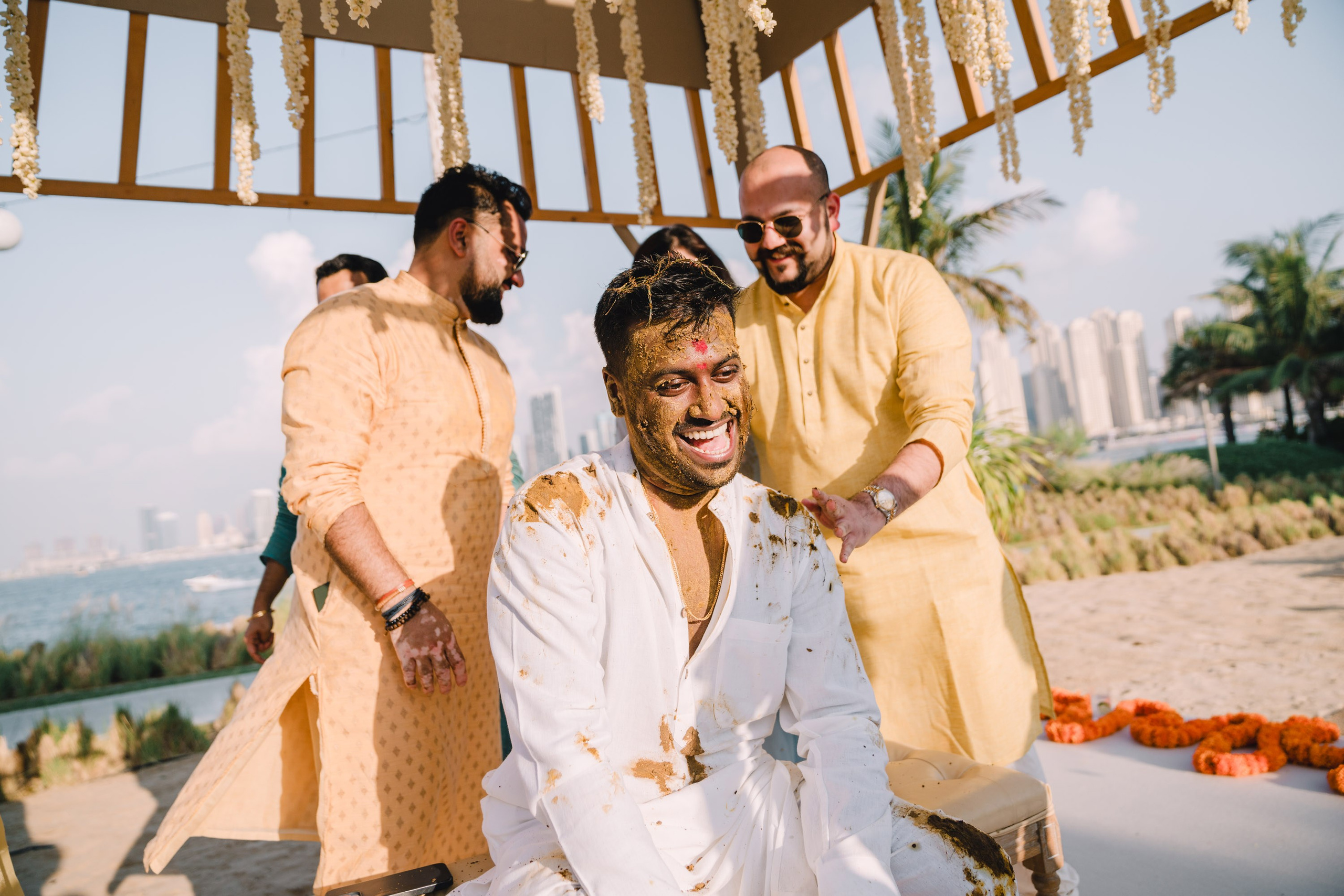 the groom and his friends are laughing on a wedding ceremony