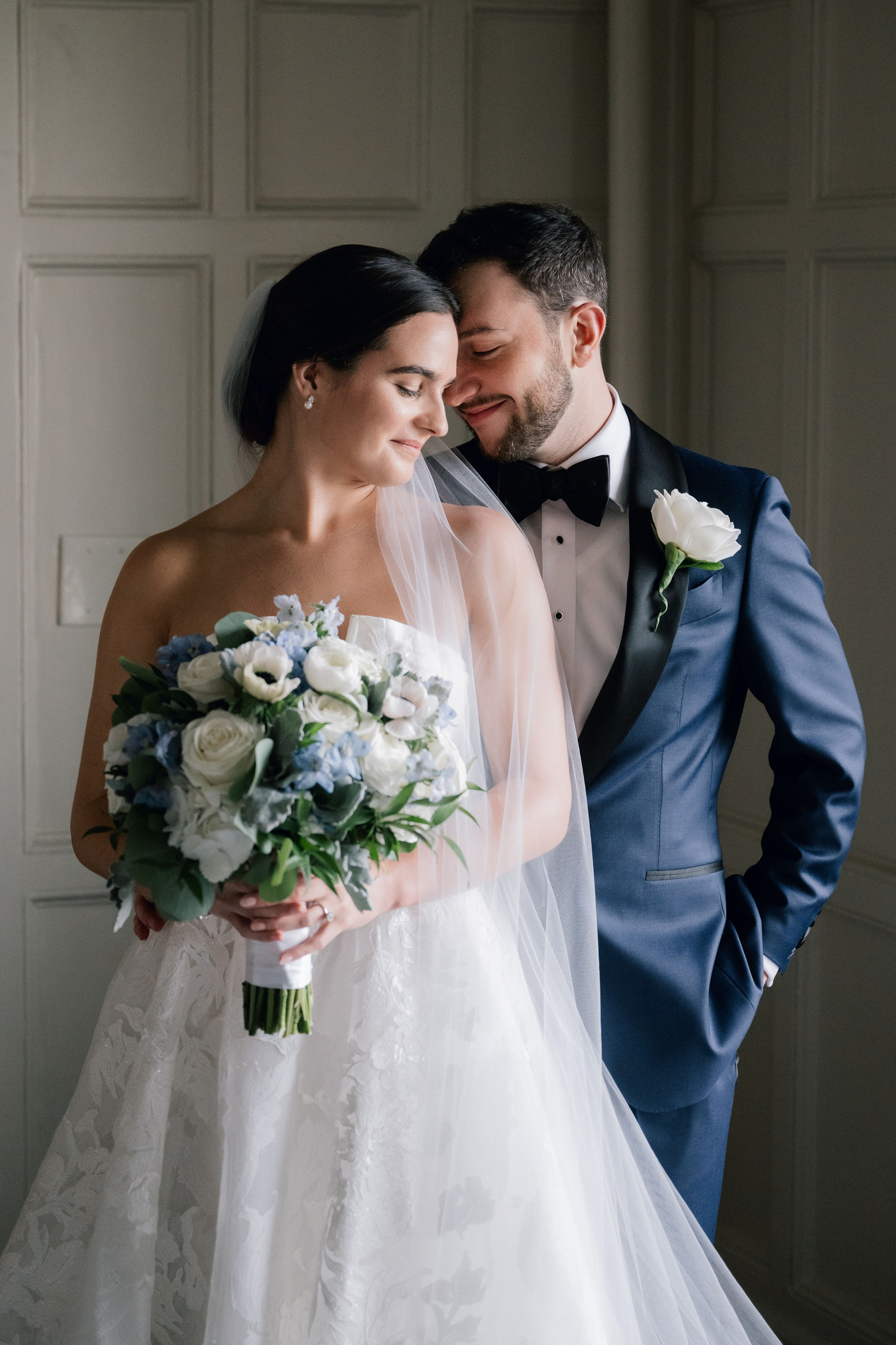 a bride and groom pose for a portrait