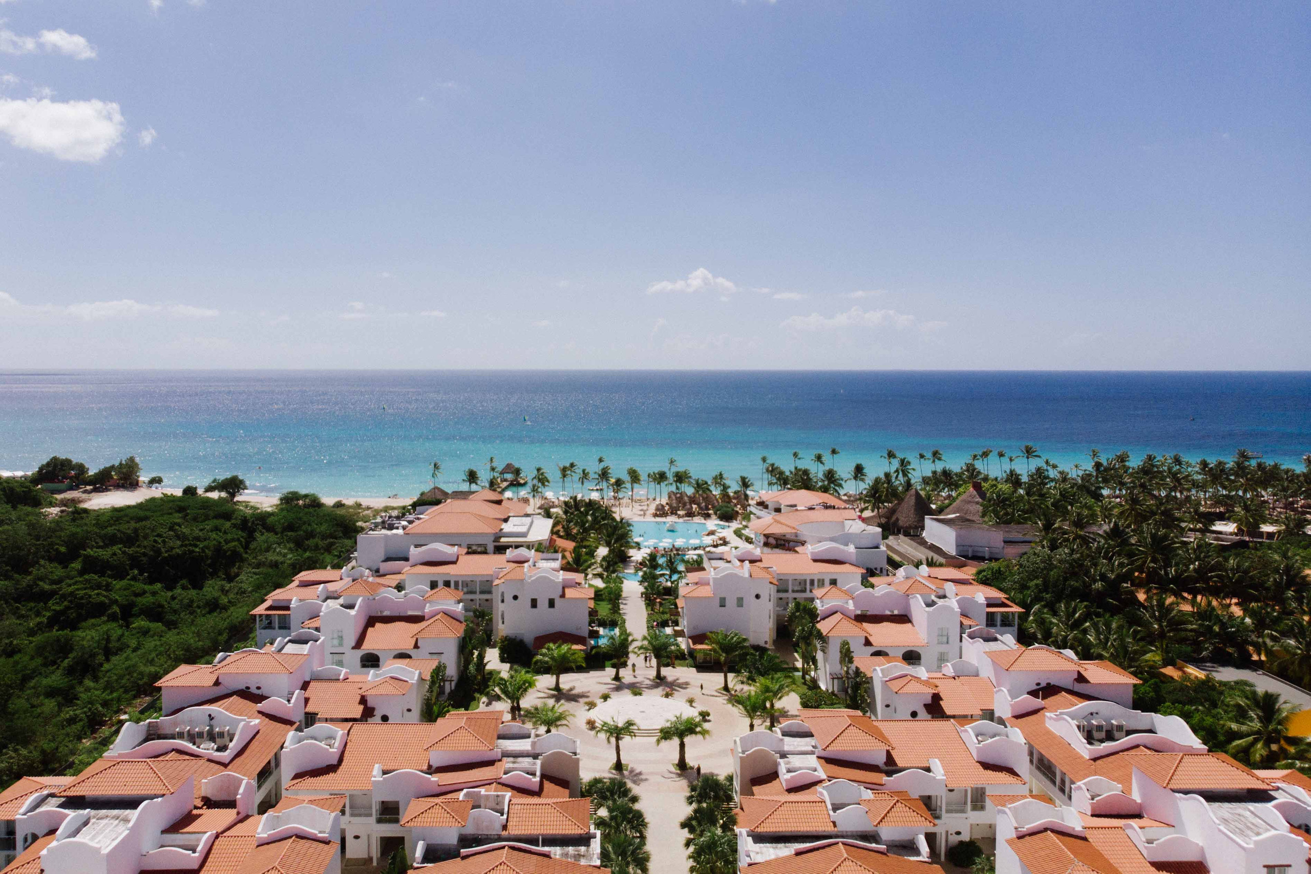 Hotel buildings on the sea coast among green spaces.