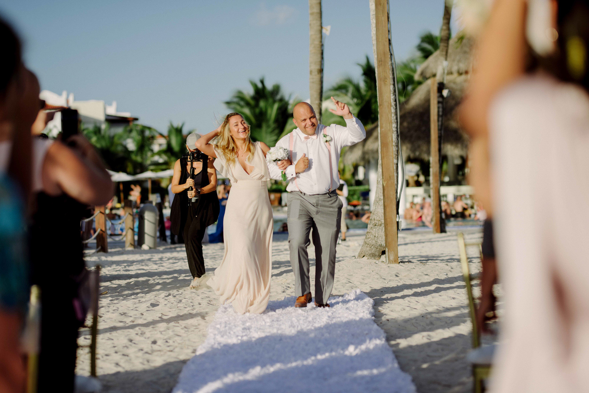 The pope leads the bride down the white path to the altar.