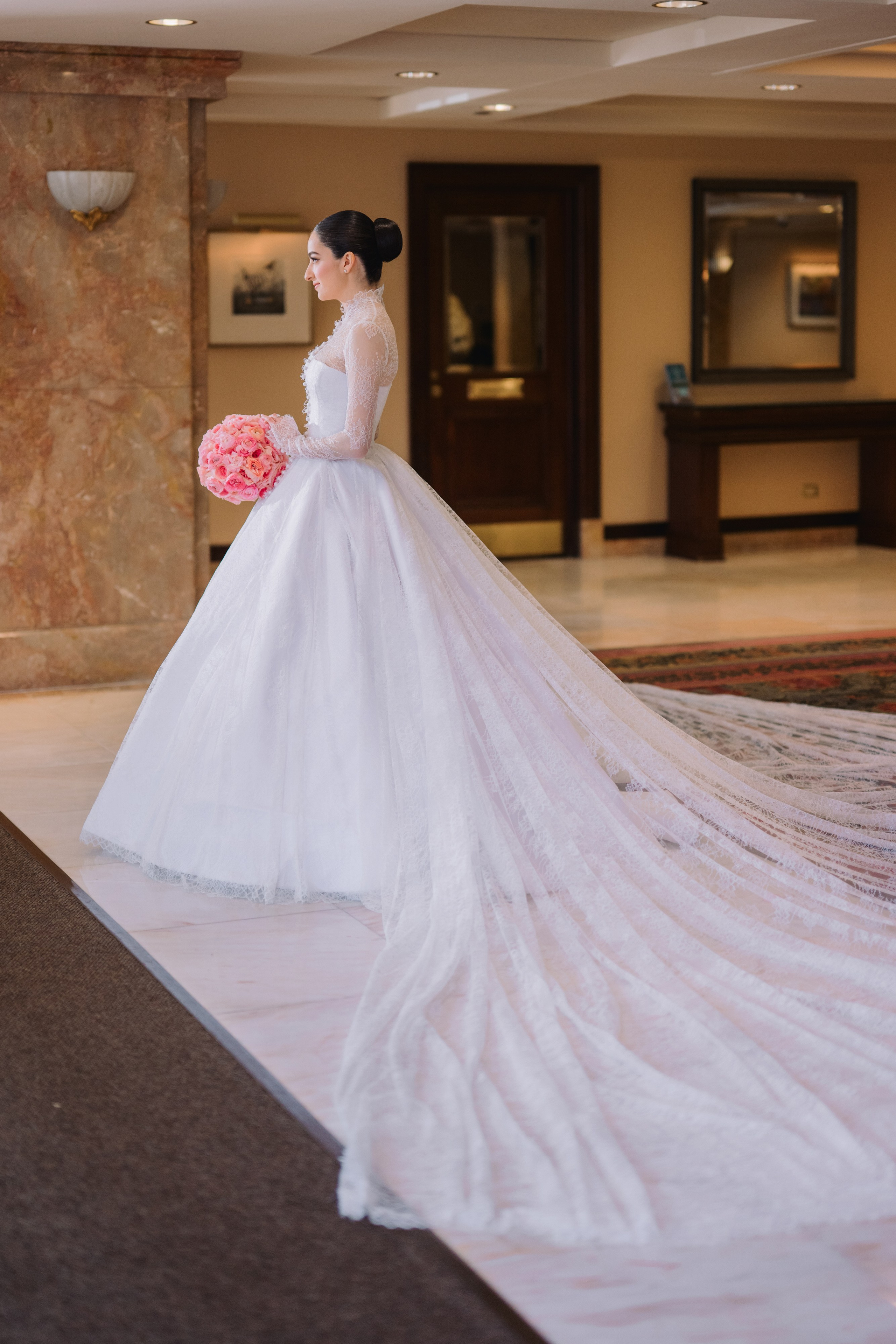 a bride in a wedding dress standing on a carpet