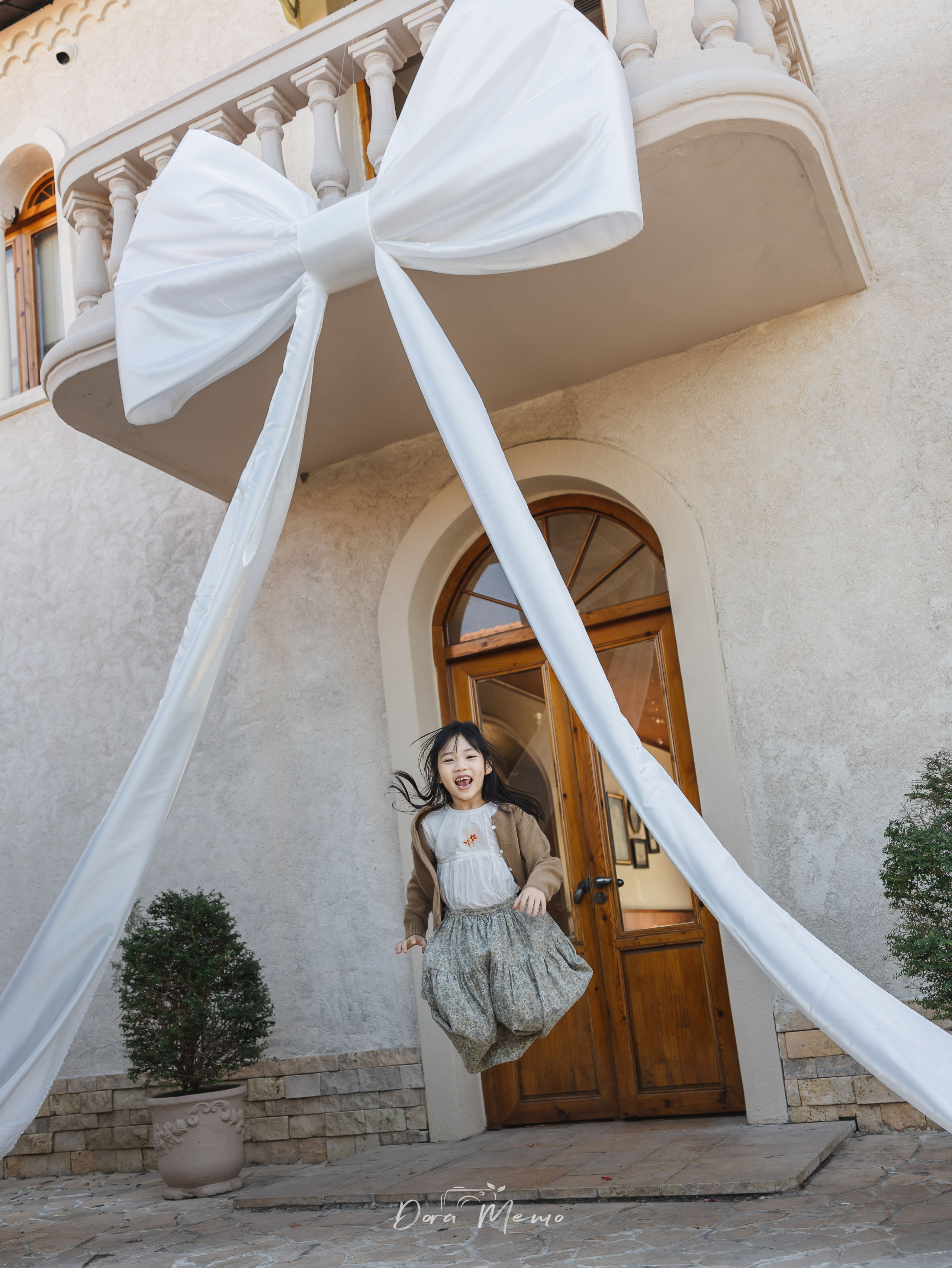 Child jumping with joy at outdoor birthday party, documentary Shanghai family photography, natural light