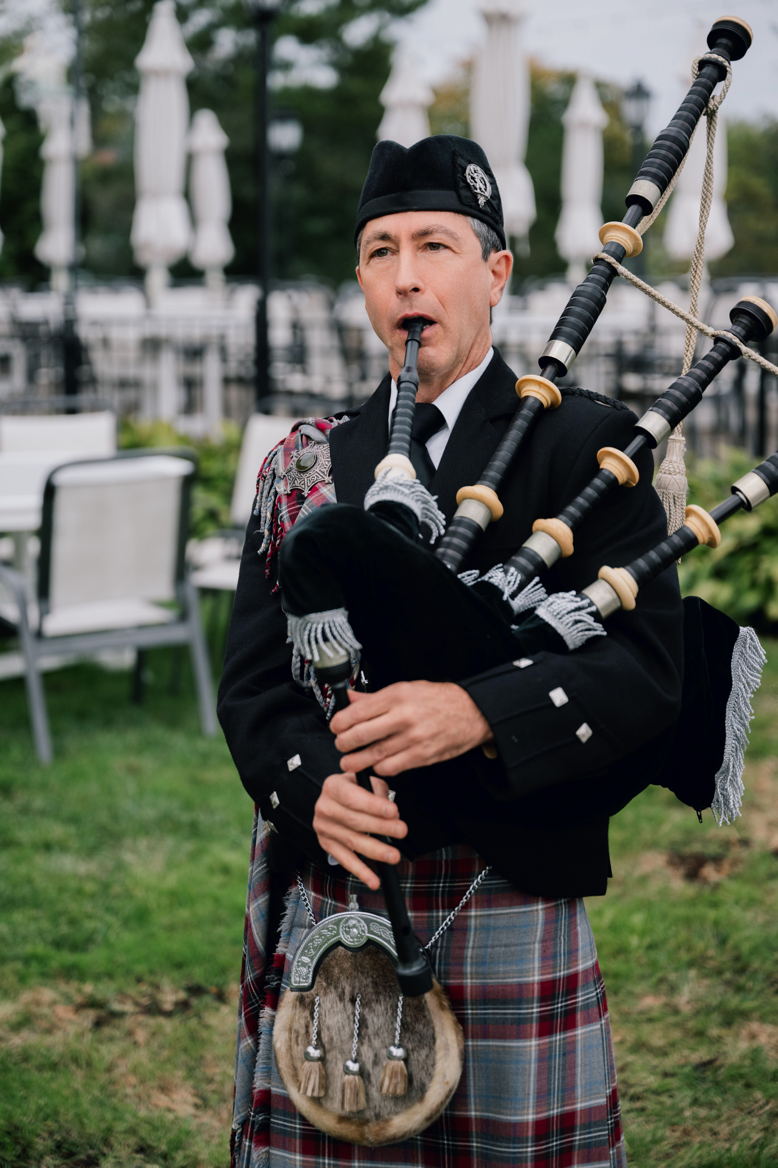 a man in a kilt playing a bagpipe