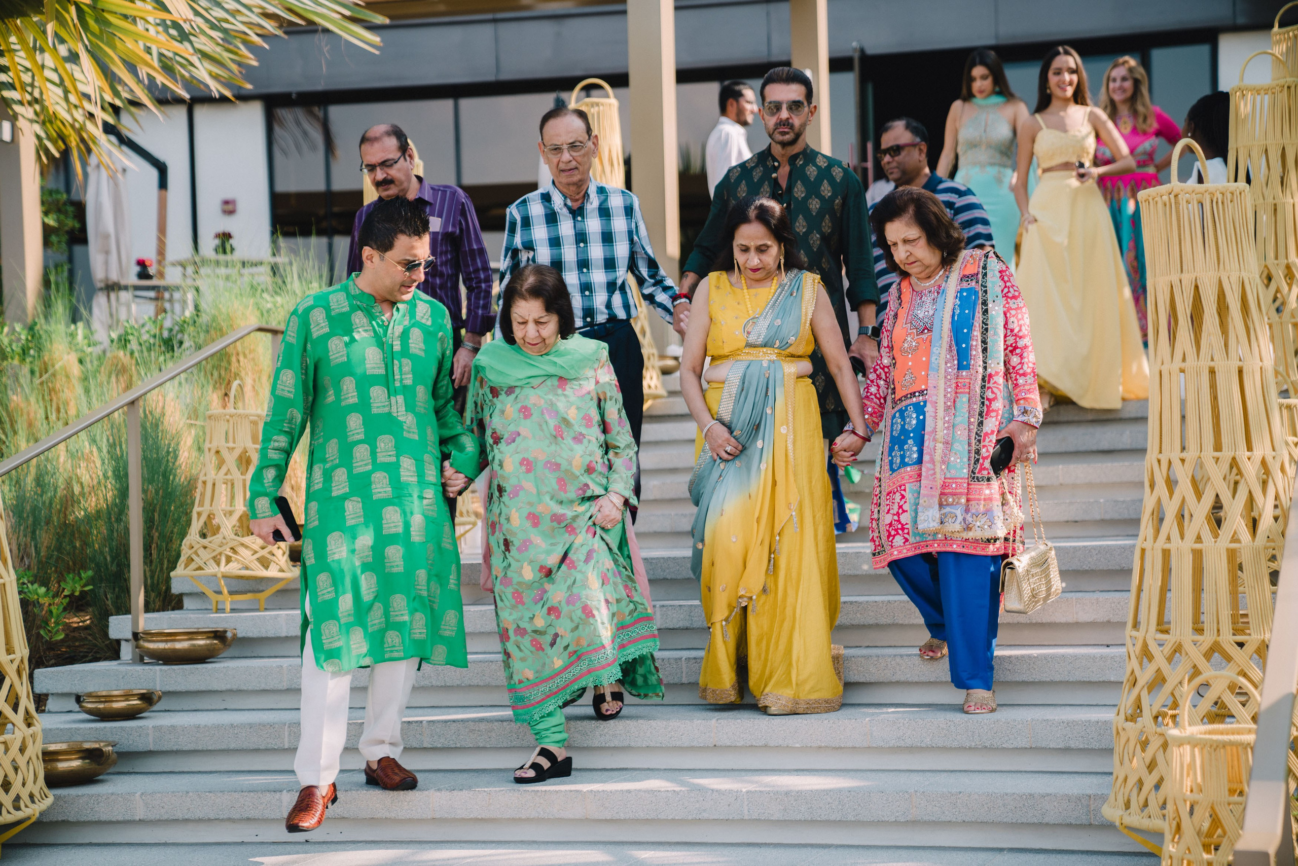 Guests in colorful dresses are taking their way to the wedding vinue