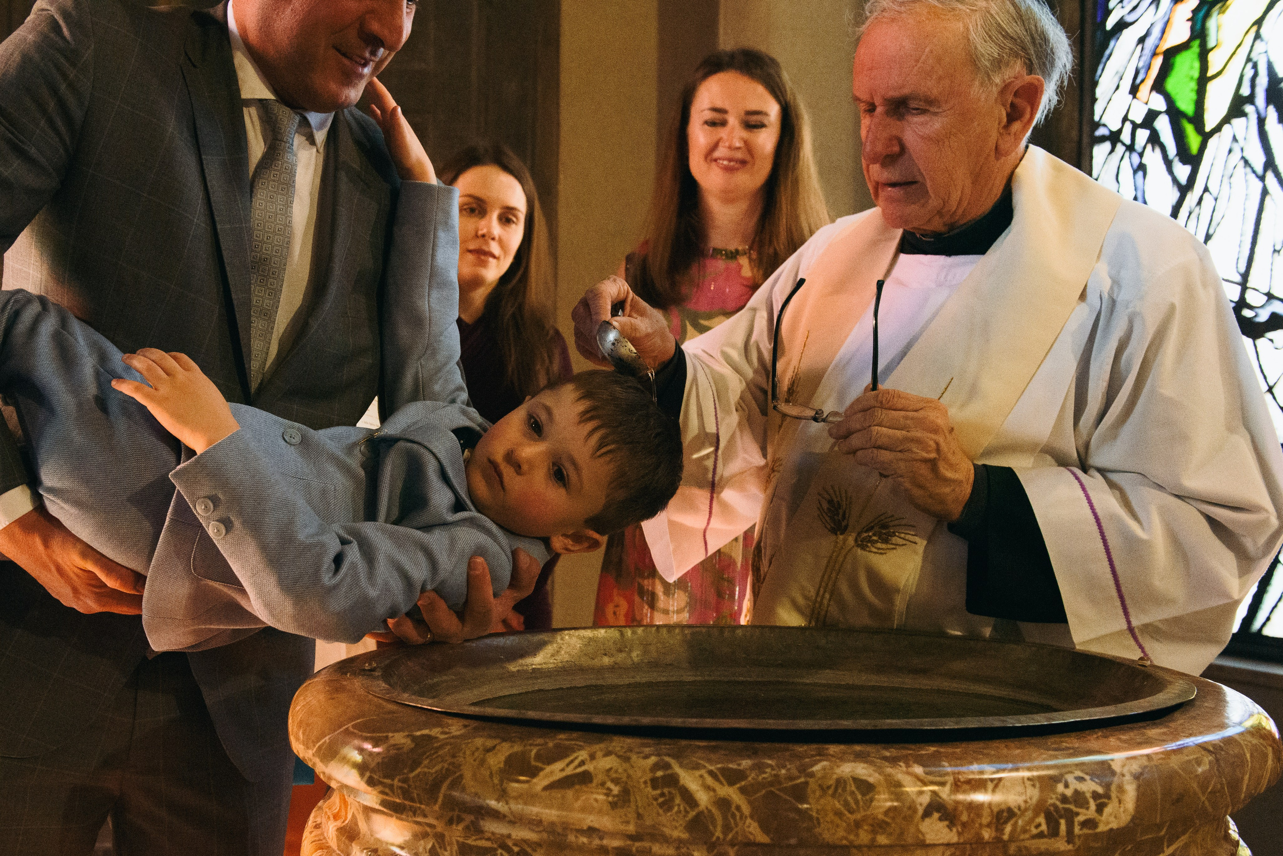 Solemn moment of Christian baptism. Church in Cerro Maggiore. Photographer Milan