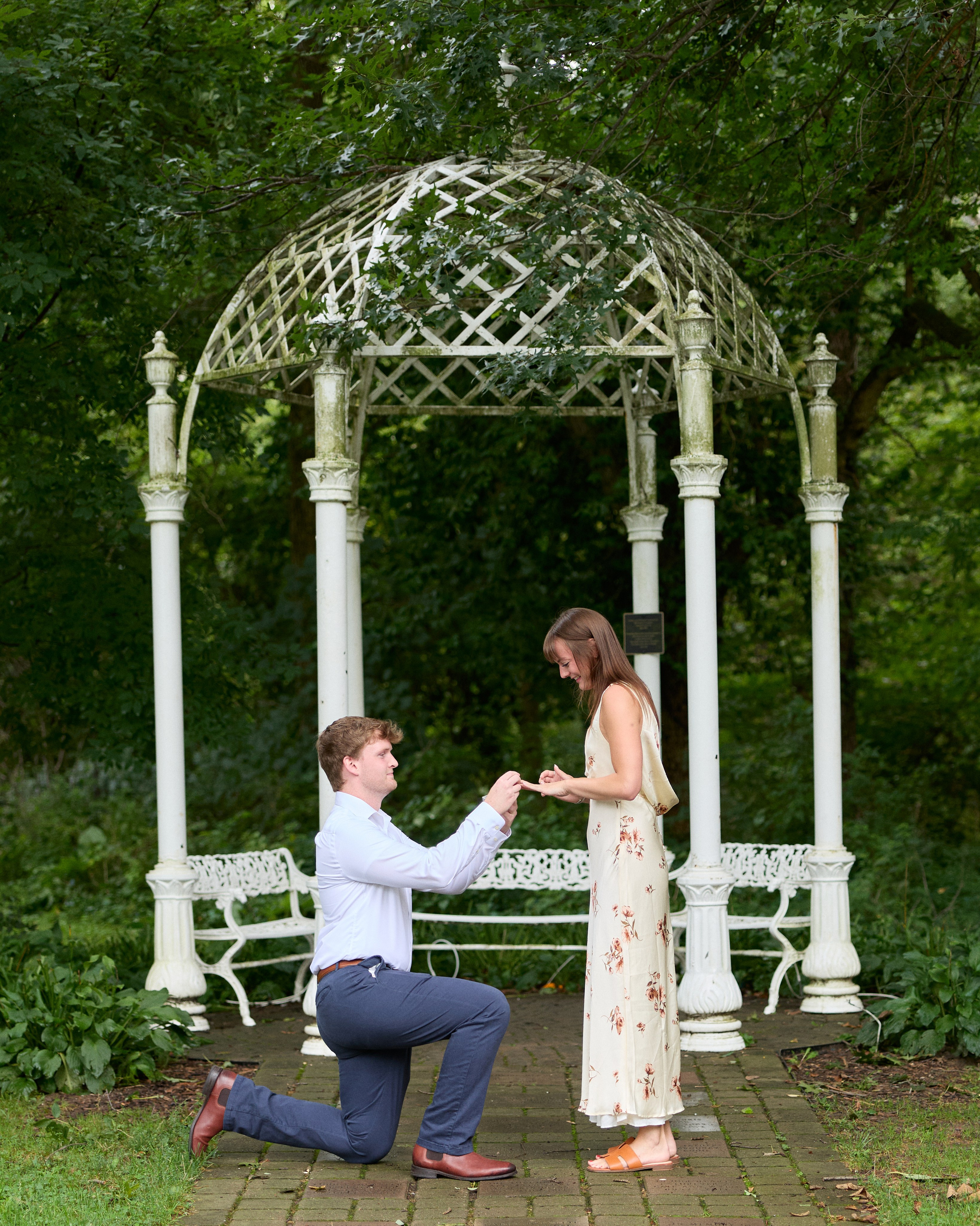 Romantic proposal beneath a white gazebo at the Park of Roses in Columbus, Ohio