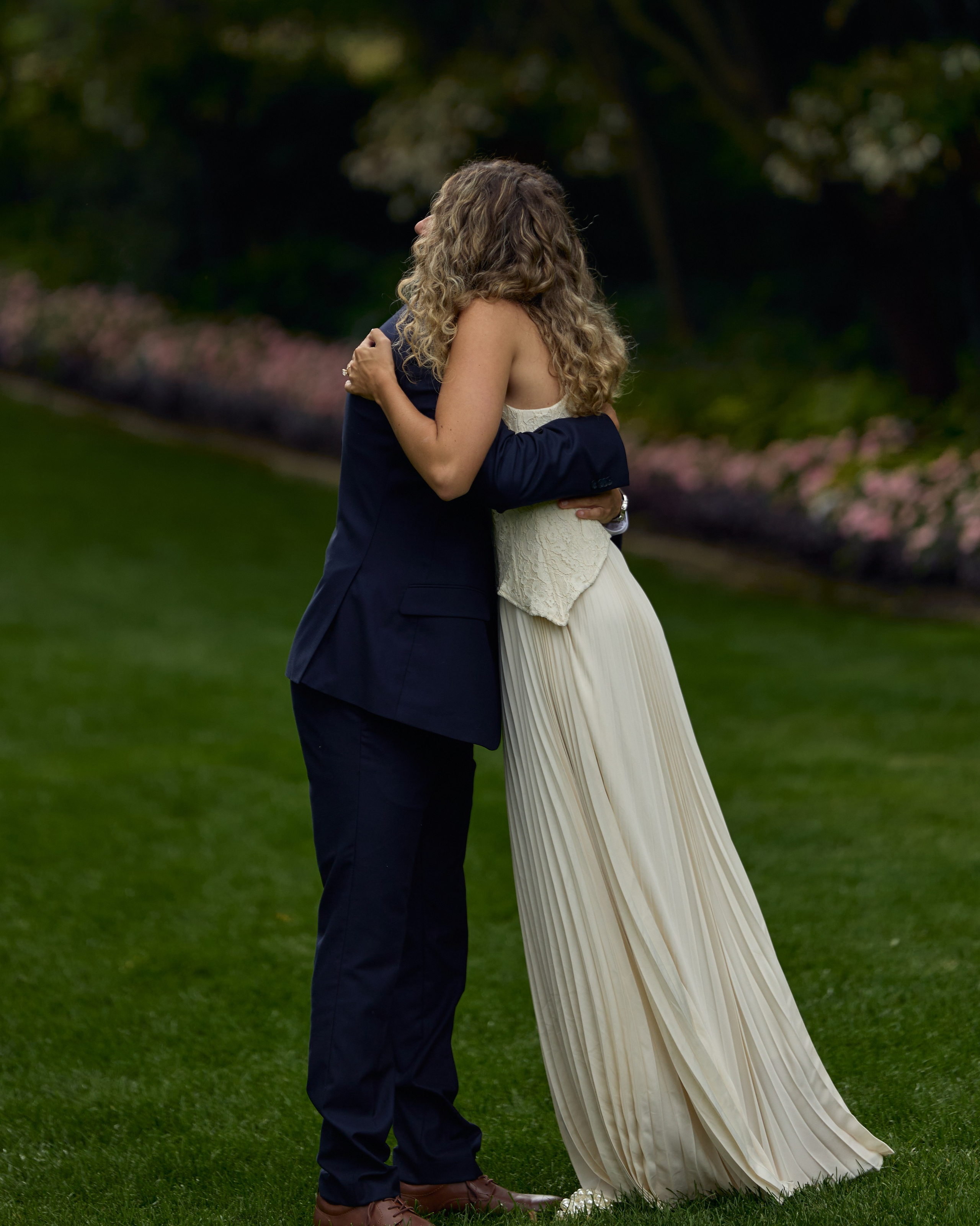 Newly engaged couple embracing on the lawn at Kingwood Center Gardens, Ohio