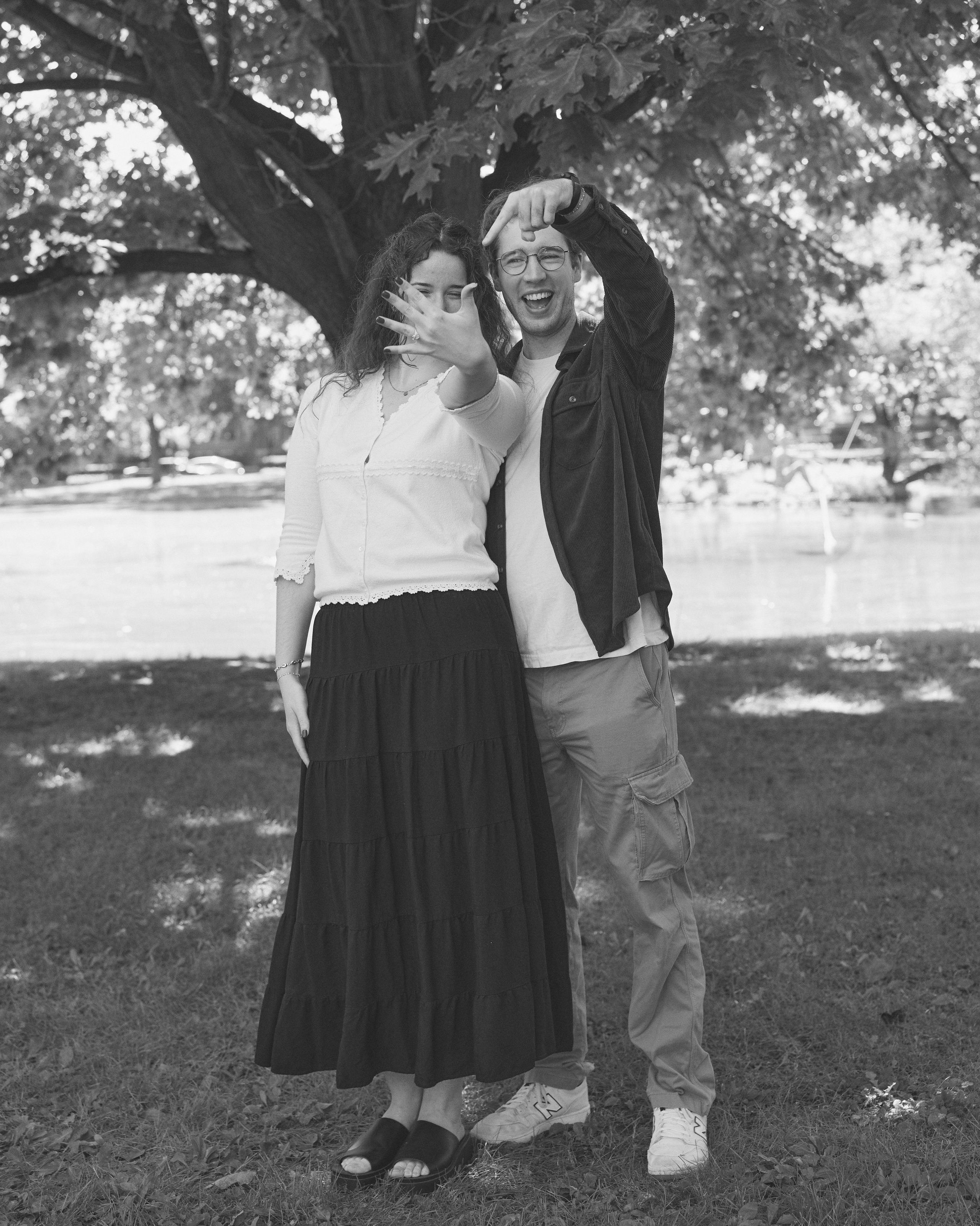 Playful black and white portrait of an engaged couple under a tree in Columbus, Ohio