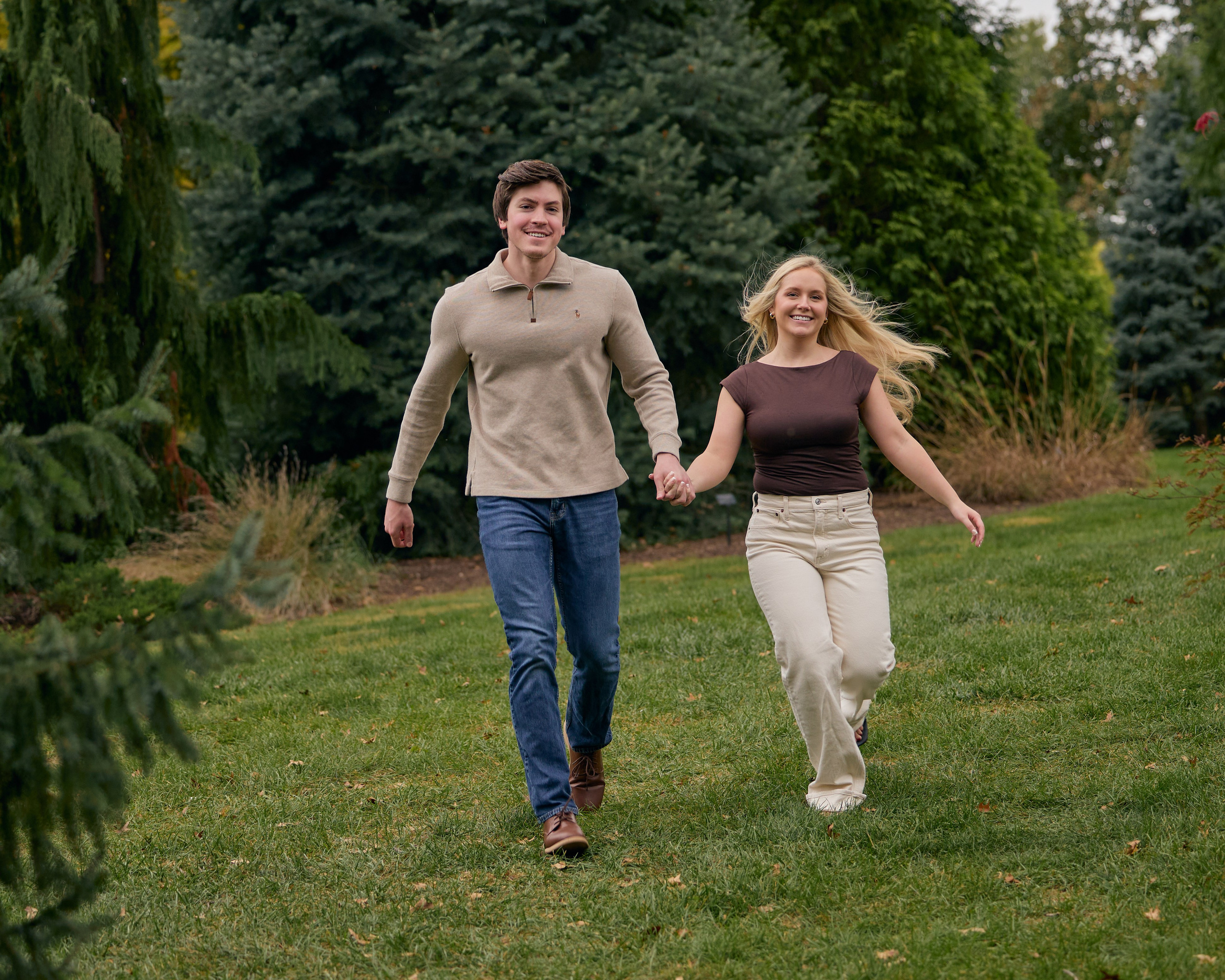 Couple running hand in hand on the lawn outside Franklin Park Conservatory in Columbus, Ohio
