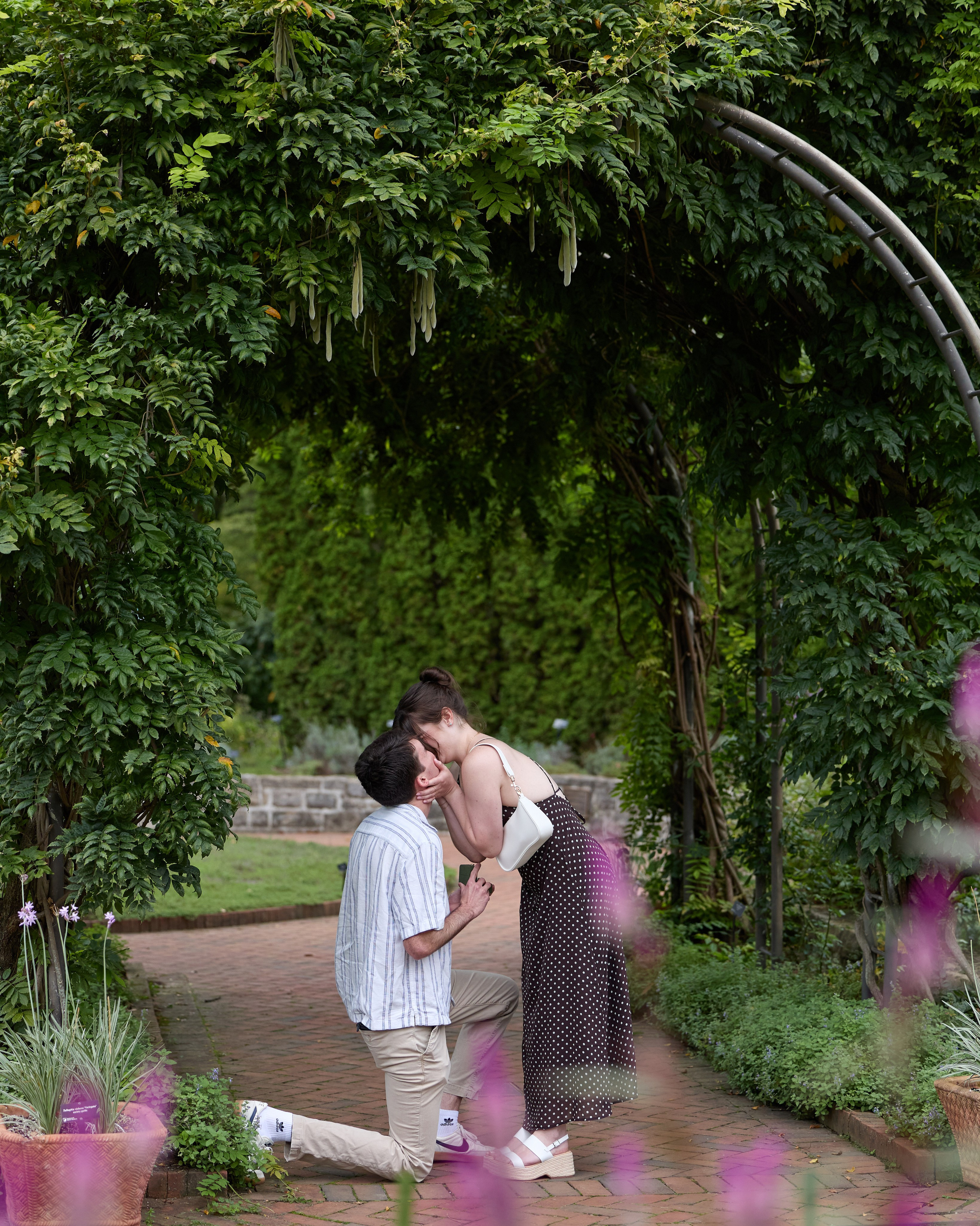 Close-up of hands with the engagement ring on a brick garden path at Inniswood Metro Gardens, Ohio