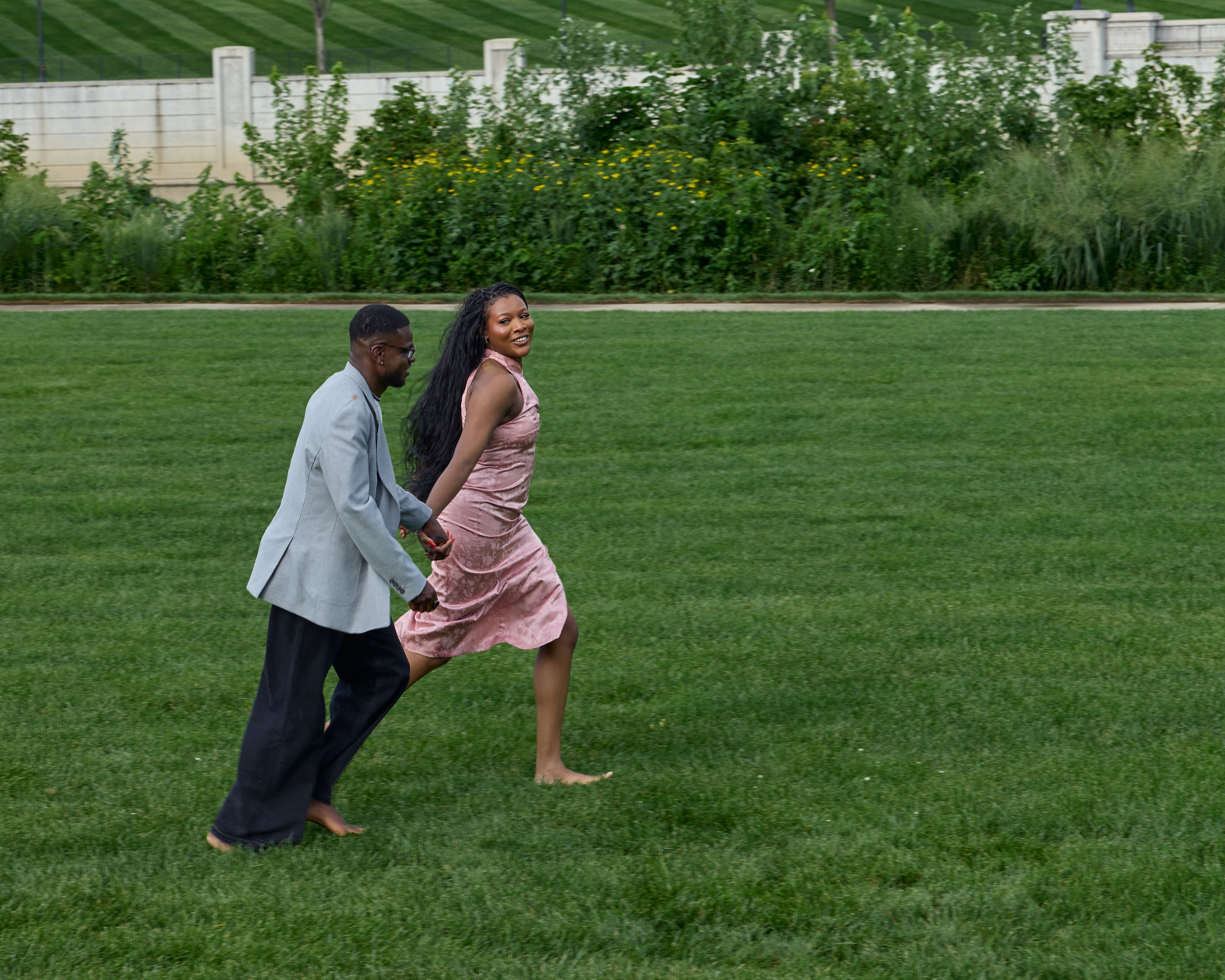 Couple running playfully across the lawn in downtown Columbus, Ohio