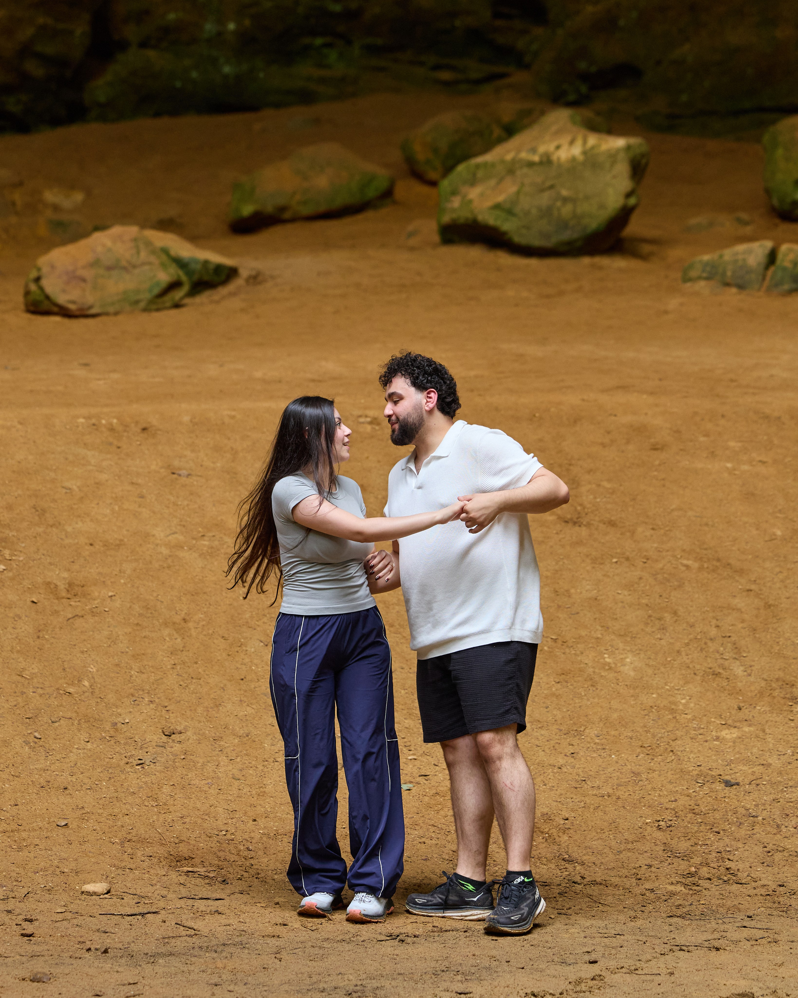 Couple hugging among the rocks of Hocking Hills, Ohio after the proposal