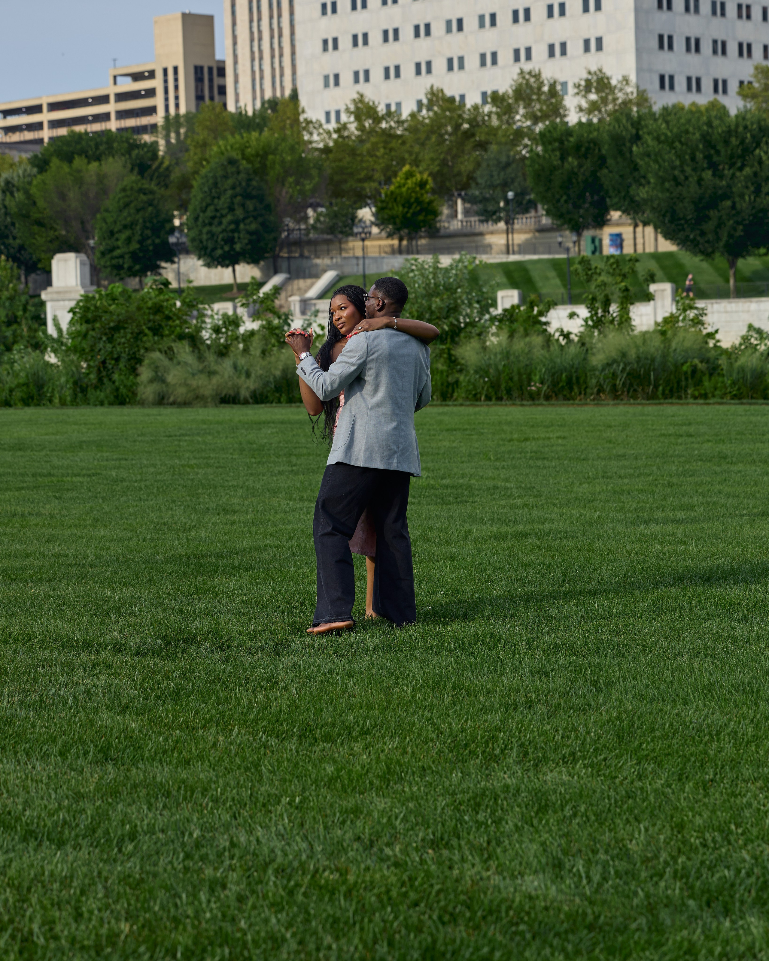 Wide lawn scene with the downtown Columbus skyline at dusk