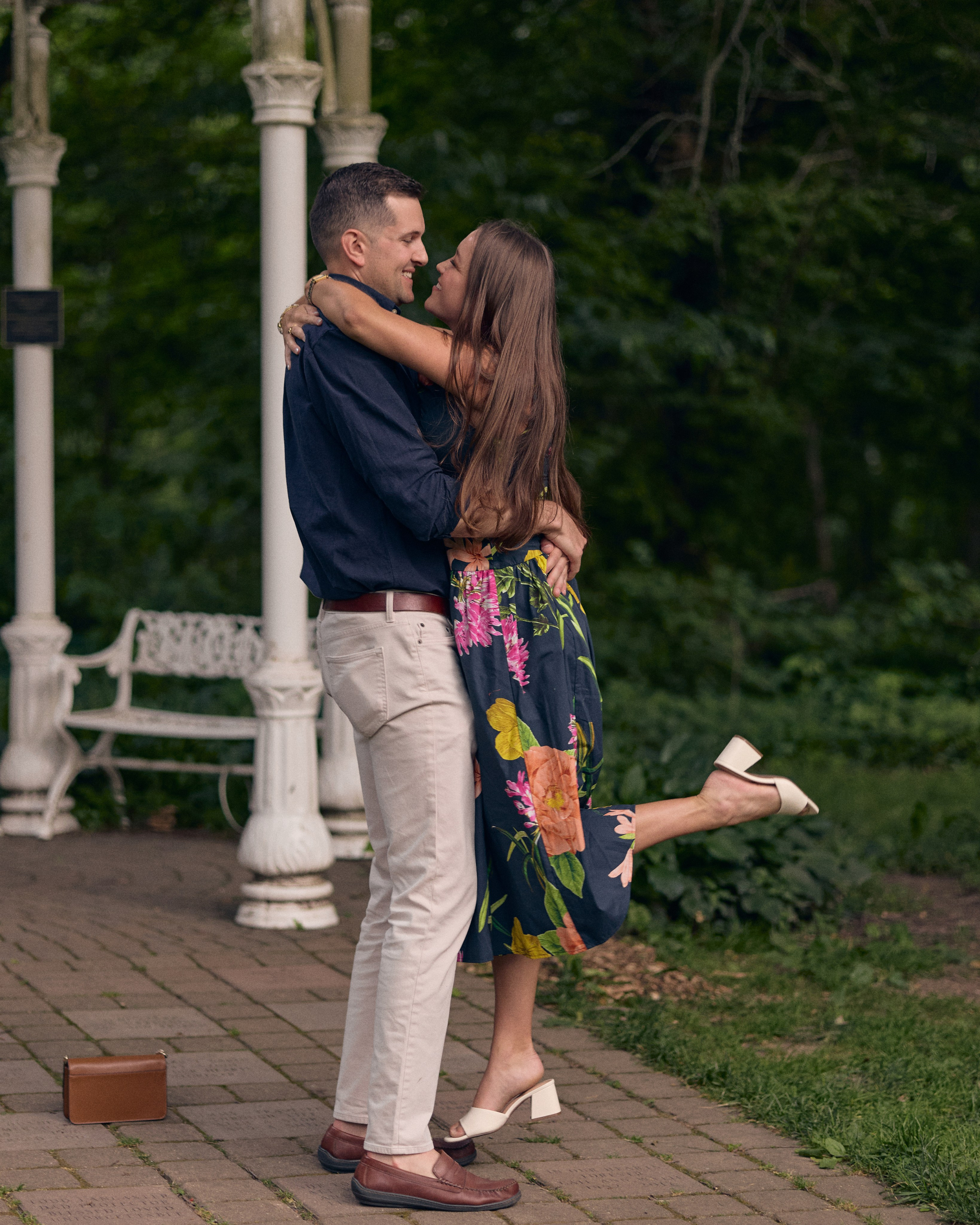 Groom lifting his fiancée for a kiss at the Park of Roses in Columbus, Ohio