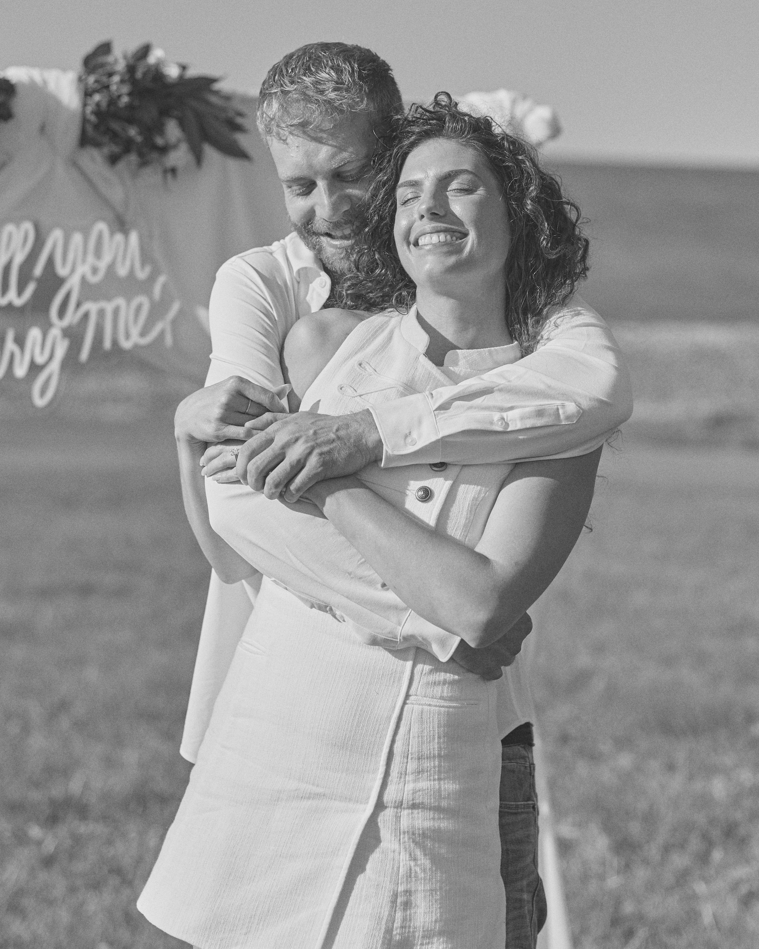 Black and white hug under the proposal arch at Alum Creek, Ohio
